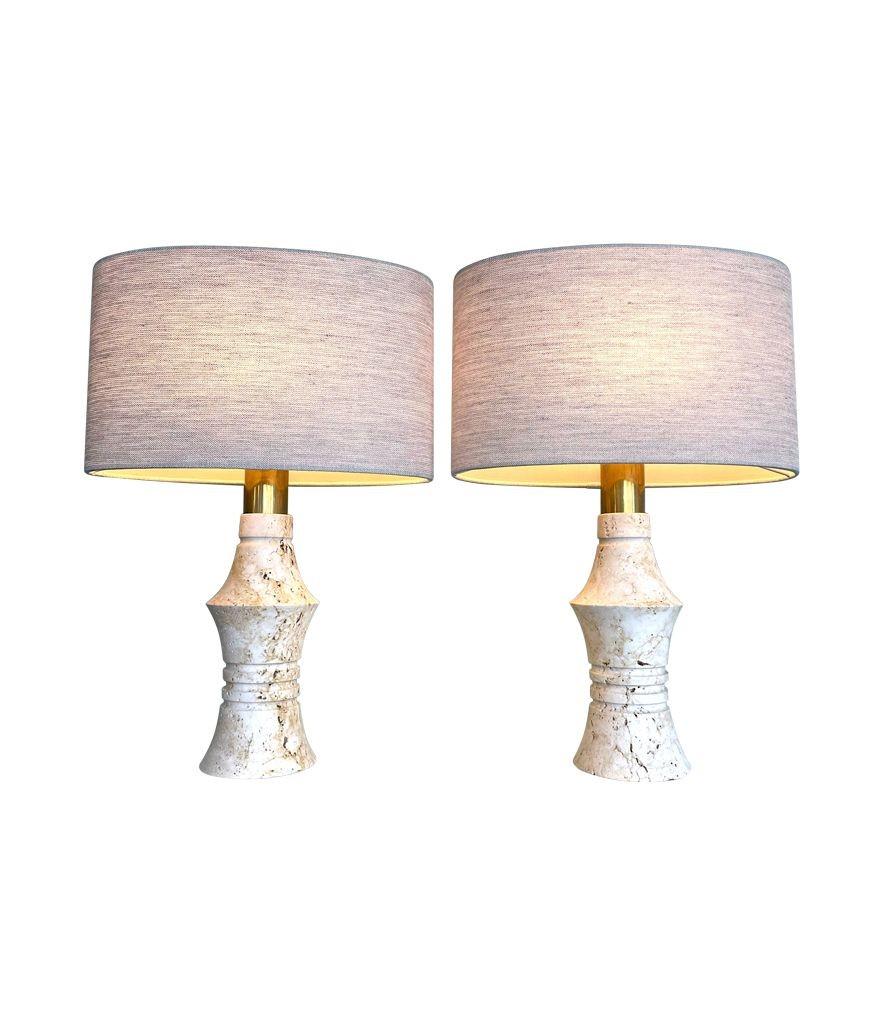 A pair of 1970s sculptural shaped travertine lamps by Fratelli Mannelli. Re wired with new brass ES fittings, antique cord flex and switch. With new bespoke oval linen shade.