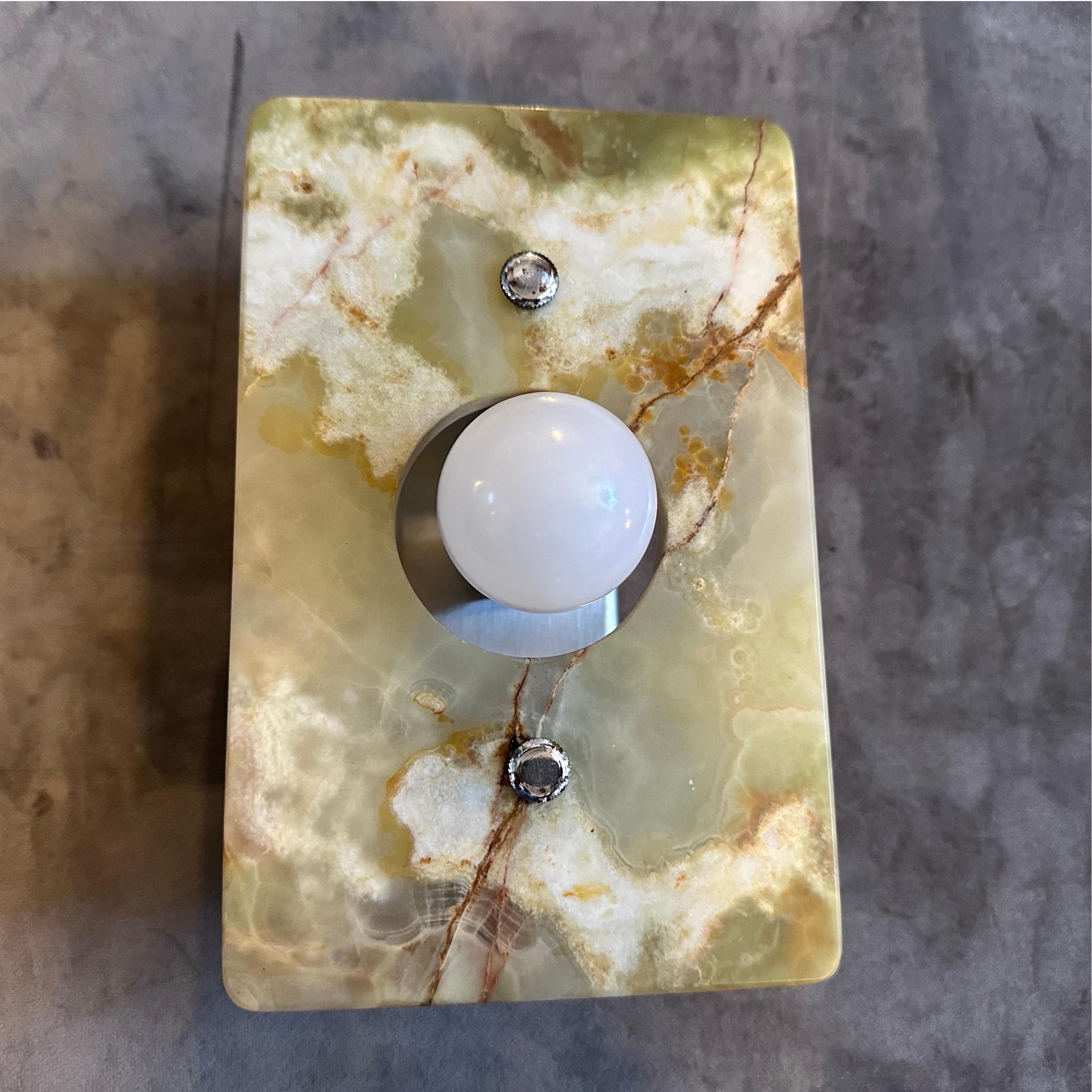 These 1970s Space Age green and brown onyx marble Italian wall sconces are elegant examples of mid-century modern design with a unique Space Age twist. Each sconce features a rectangular onyx marble panel, showcasing the natural, earthy tones and