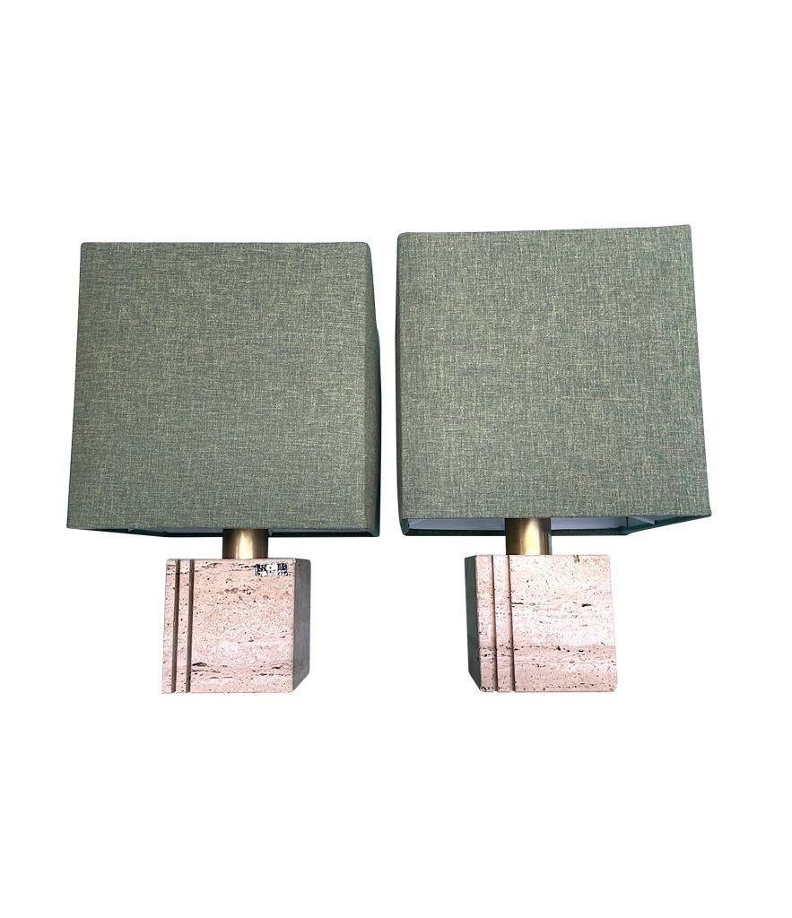 A pair of 1970s Travertine lamps by Cerri Nestore each with a double groove detail cut into the travertine. With brass stems and re wired with new brass fittings, antique gold cord flex and switch and new bespoke linen shades. With orignal labels on