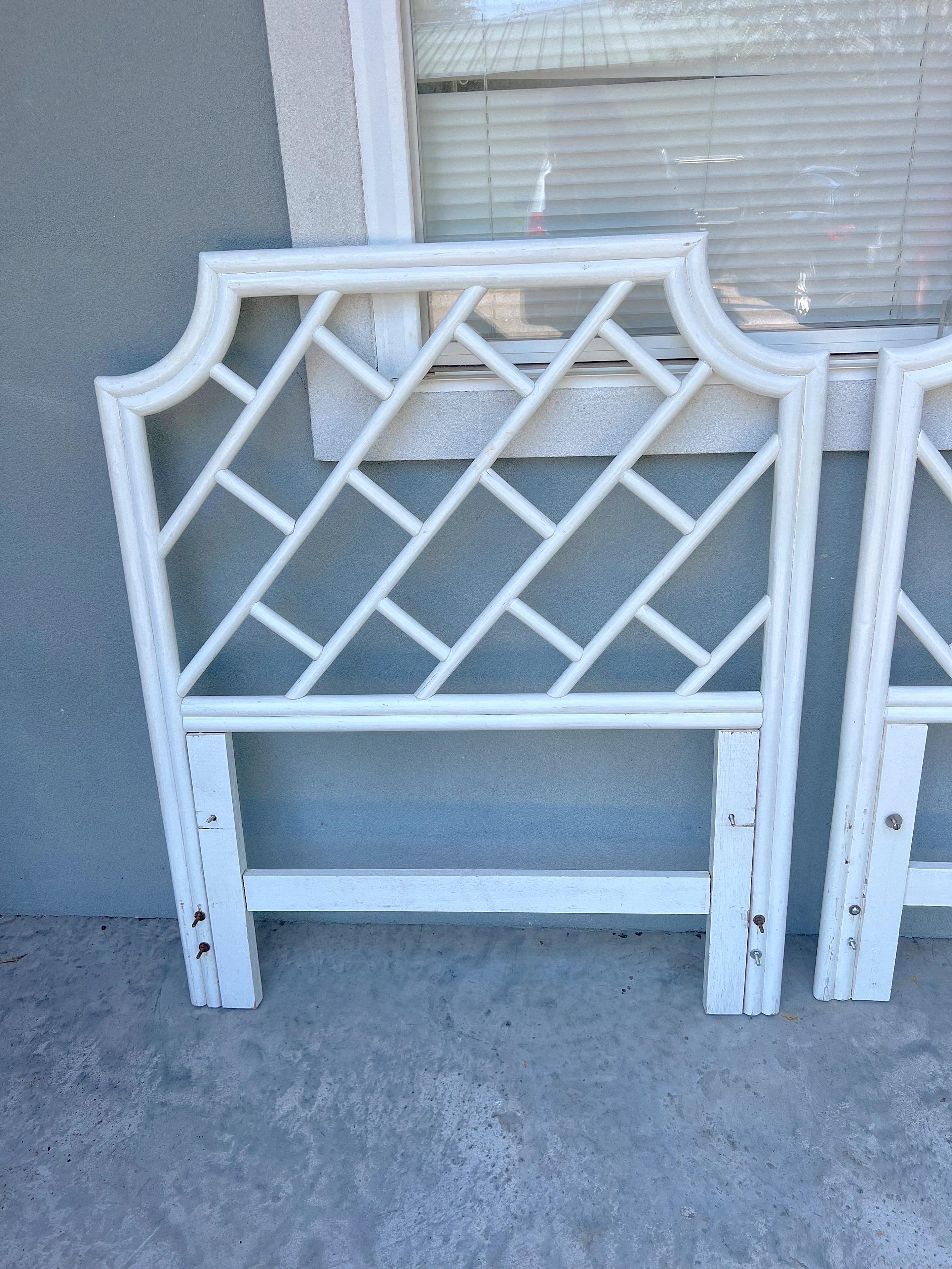 Pair of Asian chinoiserie style rattan headboards in twin size  finished in gloss white. Perfect for a guest room or pushed together for a dramatic king bed. Very good condition with minor imperfections consistent with age. Price is for the