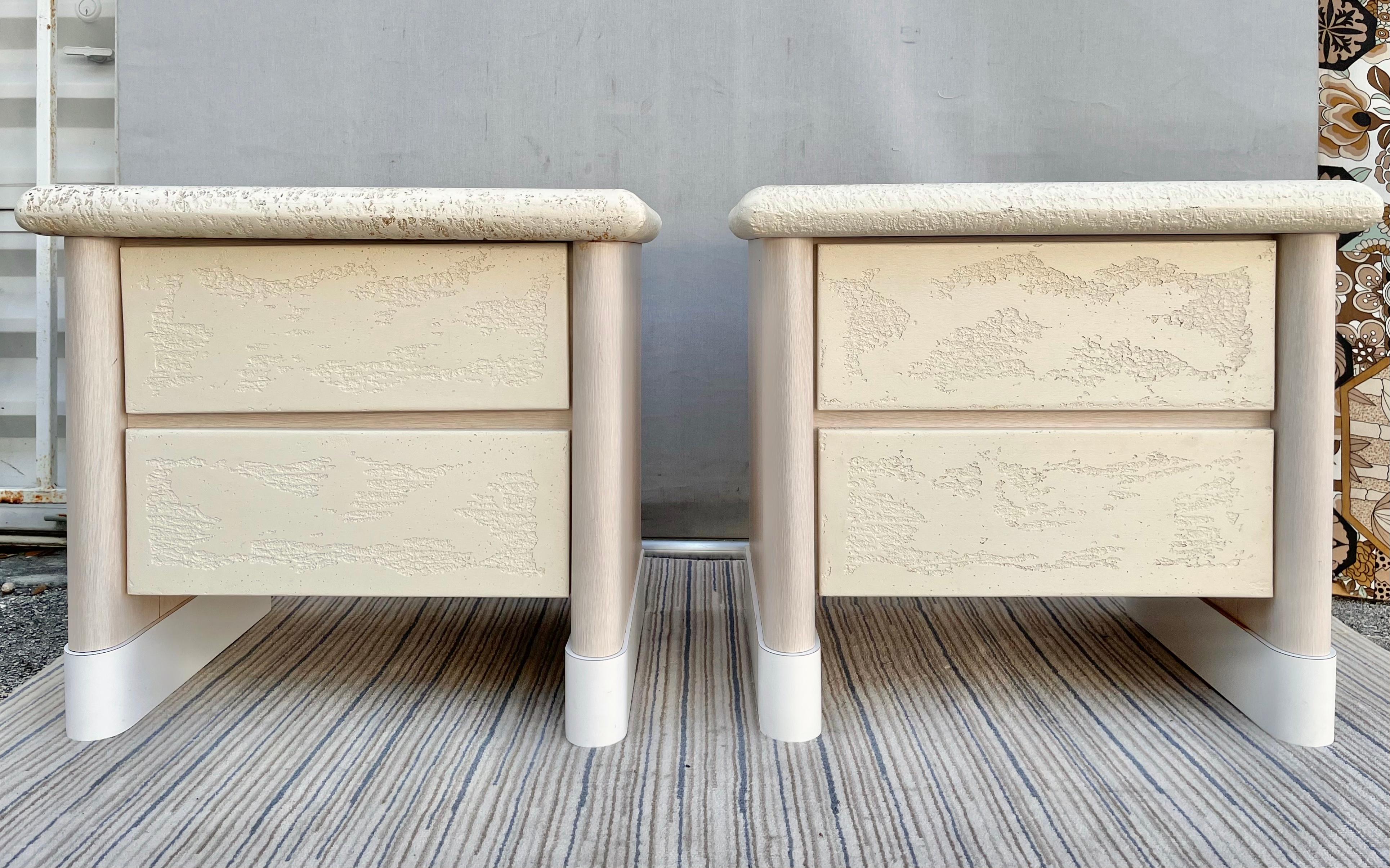 A pair of robust vintage in a Latin American Postmodern Style textured faux stone nightstands. Circa 1980s 
Featured two drawers with textured faux stone plaster fronts and a matching textured rounded edges trims at the tops, with a smooth faux