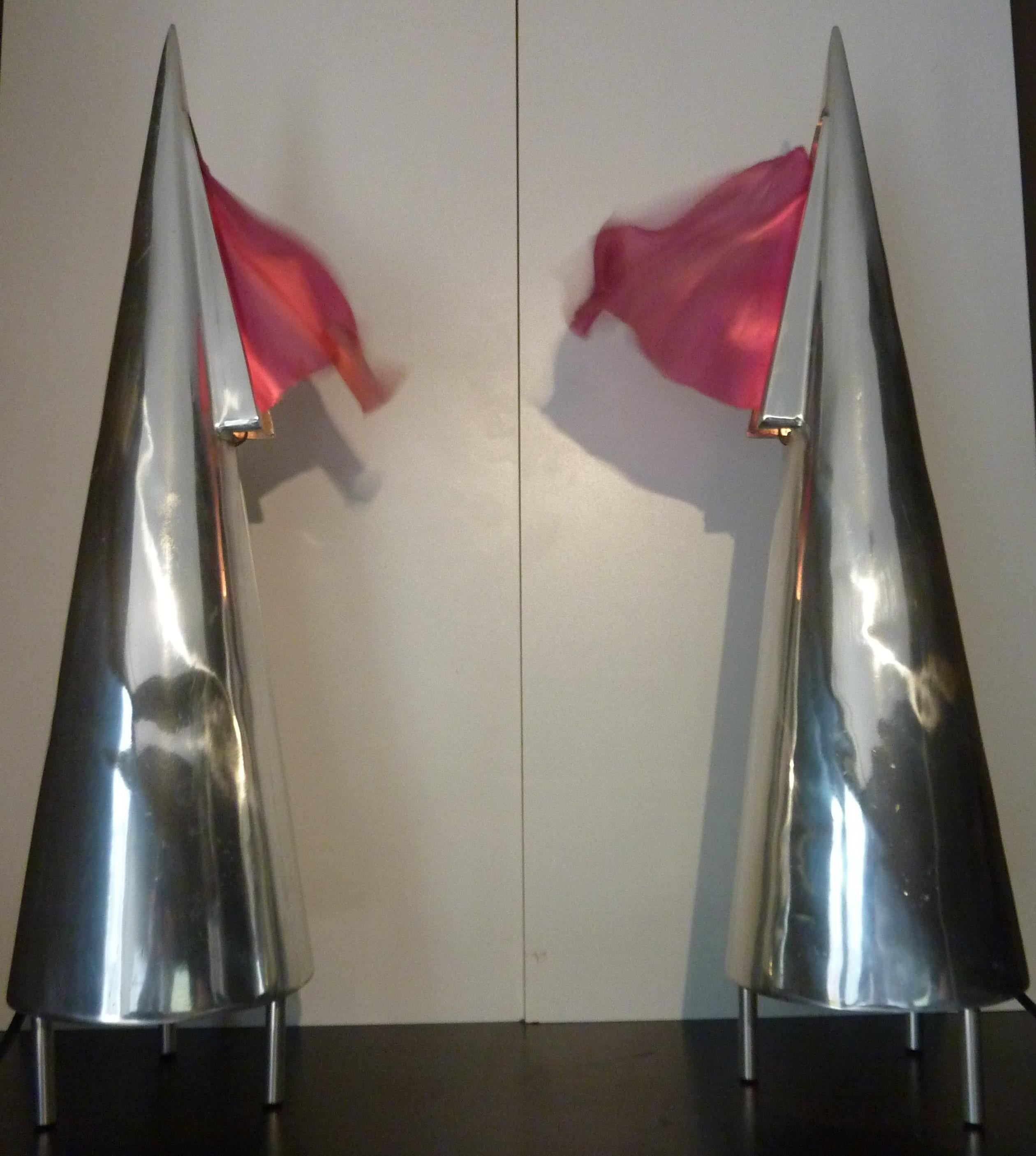 A Pair of 1981 Maestrale Table Lamps by Denis Santachiara
Manufacturer: Domodinamica, Italy
Provenance: Acquired directly from the designer in 1994 by the present owner.
These aluminium table lamps feature an internal van that makes the silk flag