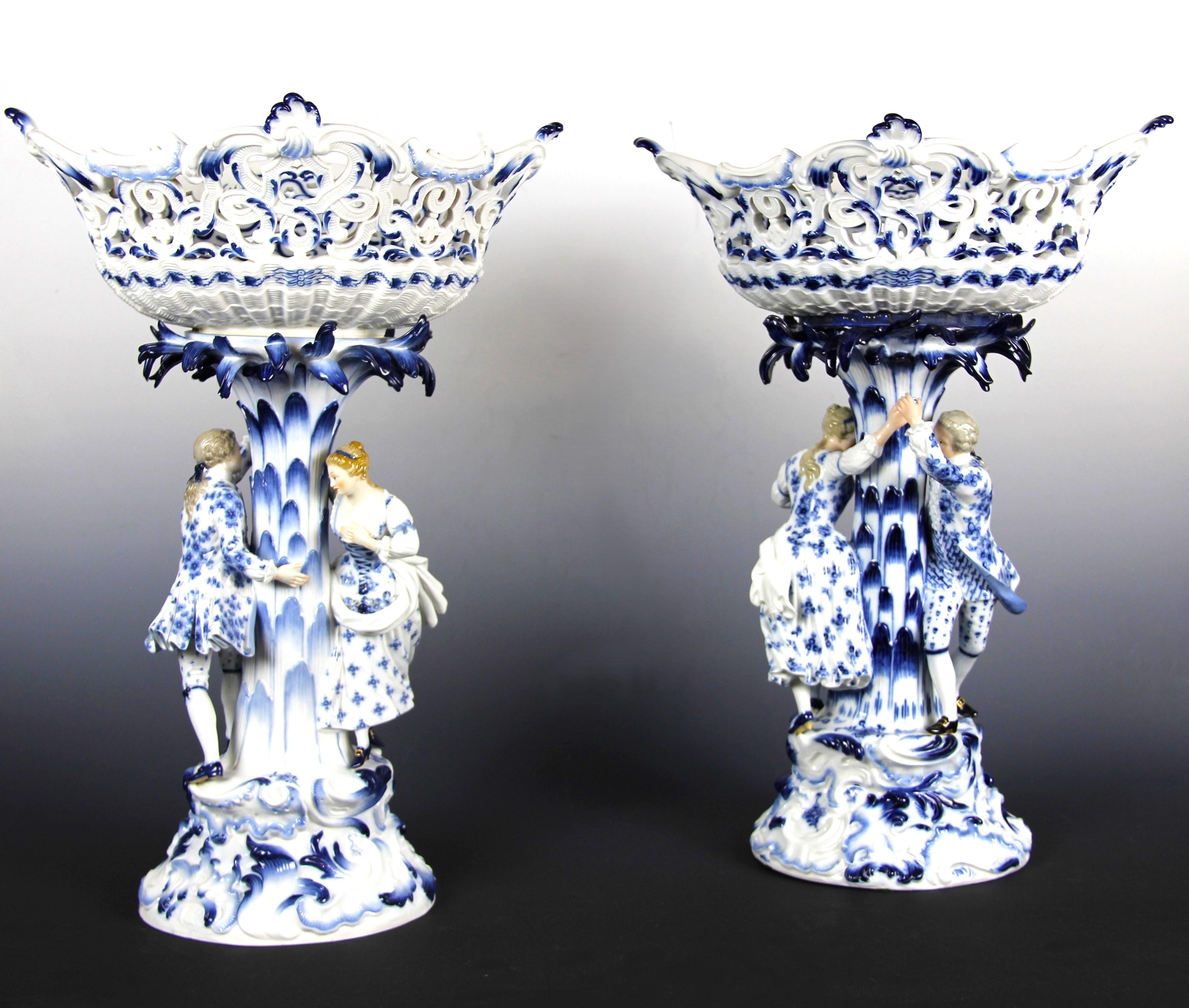 A Pair of 19th Century Meissen Porcelain Blue and White Hide and Seek Centerpieces. The baskets are oval with pierced rocaille-style scrollwork along the rim, extending outward at four points. The exterior is decorated with molded relief details,