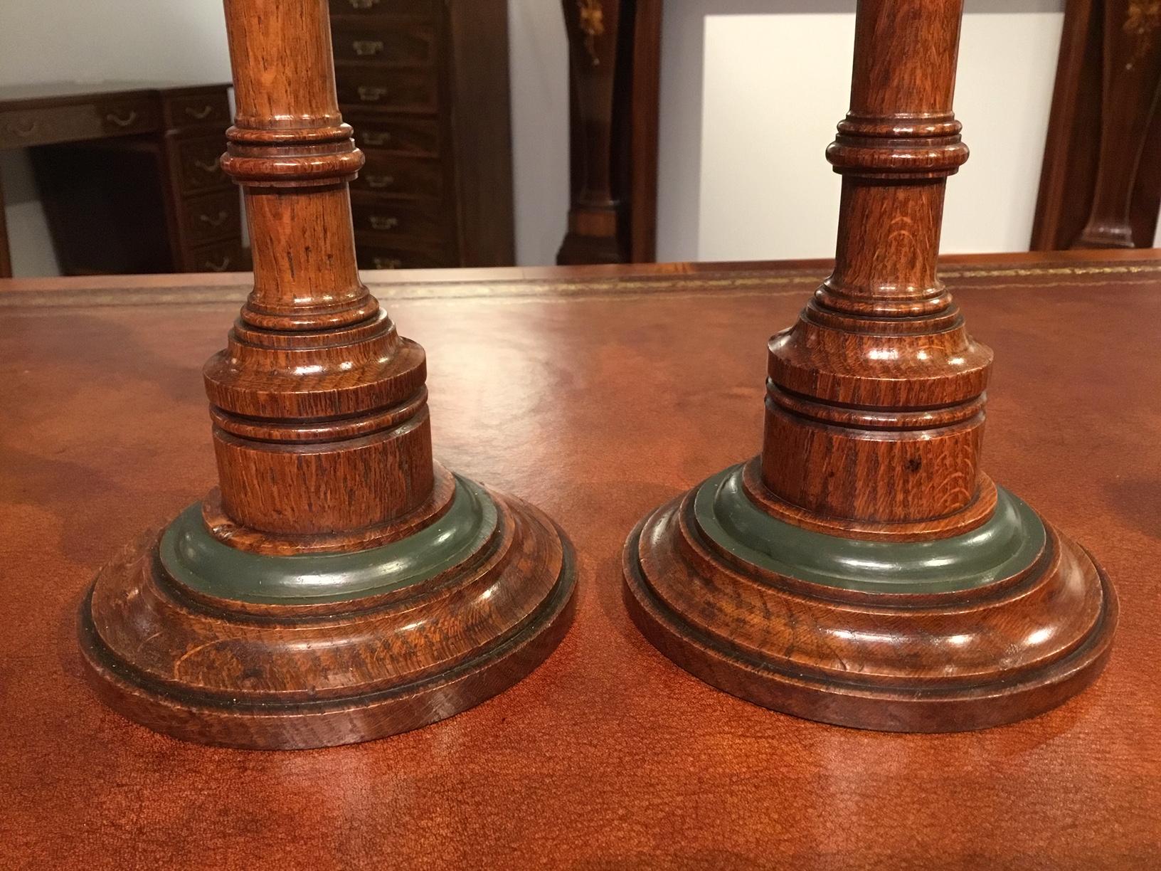 A lovely pair of 19th century Aesthetic period oak candle sticks. Each having a wonderful turned column with polychrome detail, supported on a lovely turned circular base with brass sconces. English, circa 1870-1880

Dimensions: 5