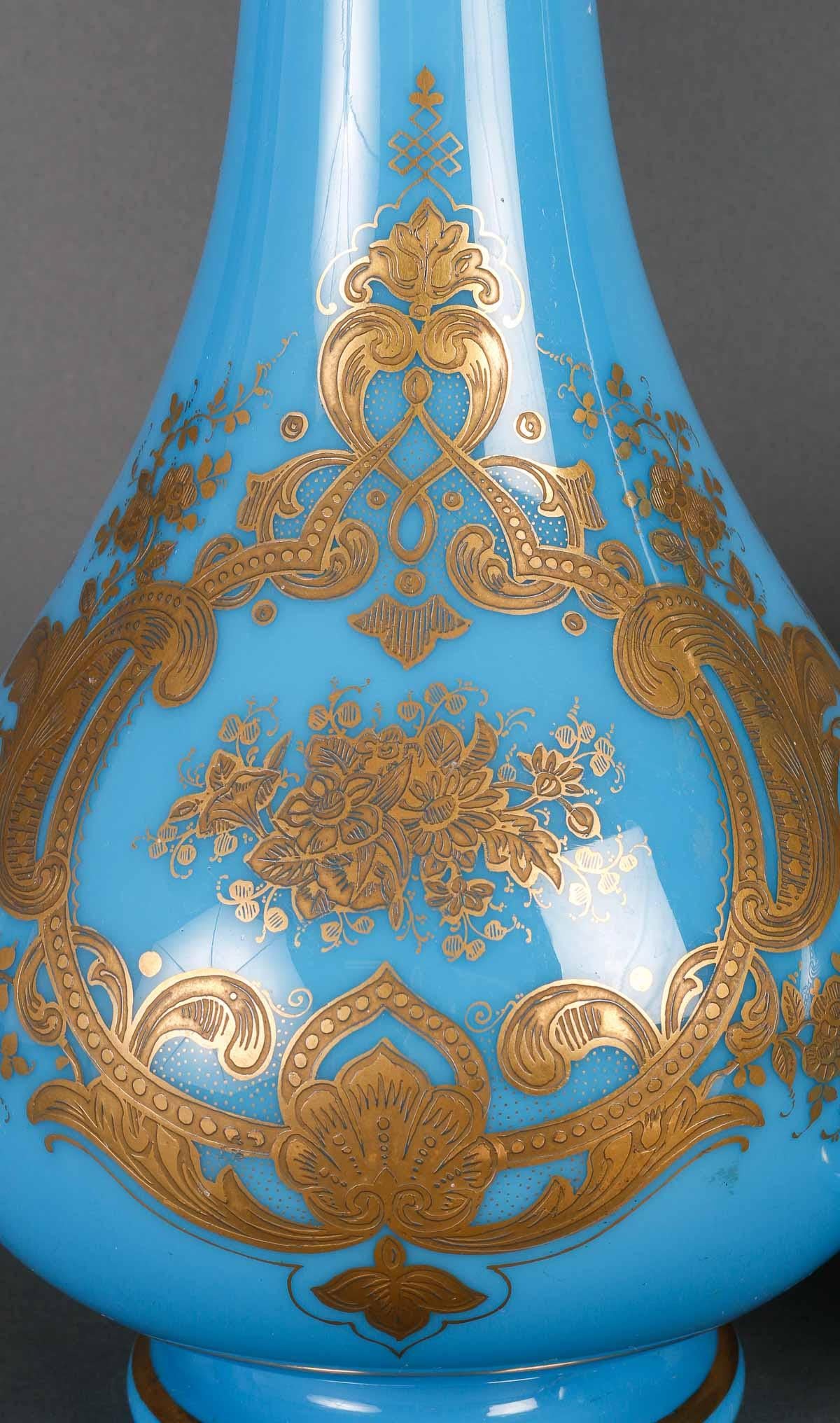 A pair of 19th century blue opaline vases.

Pair of 19th century vases, Napoleon III period, blue opaline enhanced with gold.
h: 40cm, d: 20cm