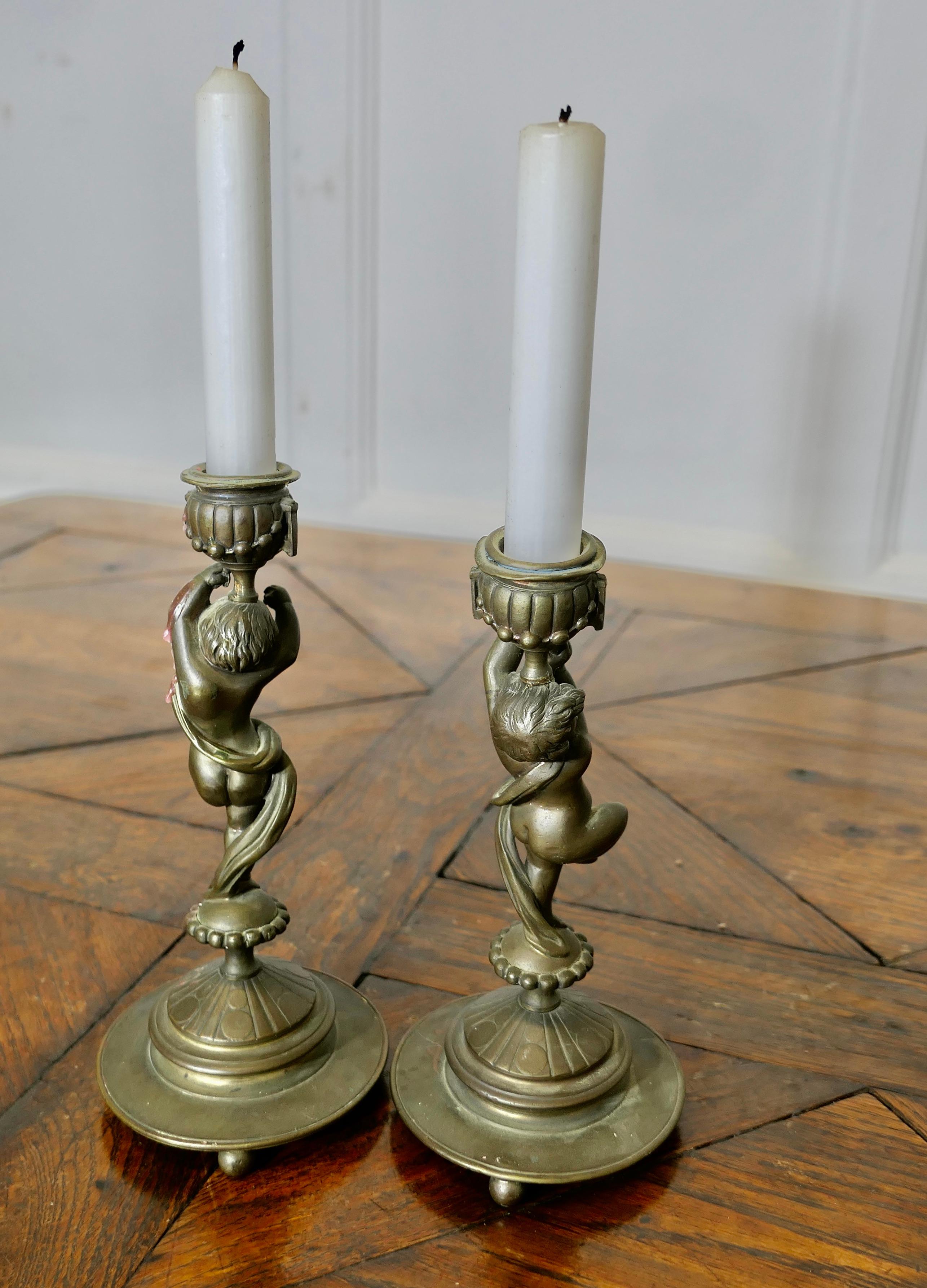 A Pair of 19th Century Brass Candle Sticks with Dancing Cherubs For Sale 1