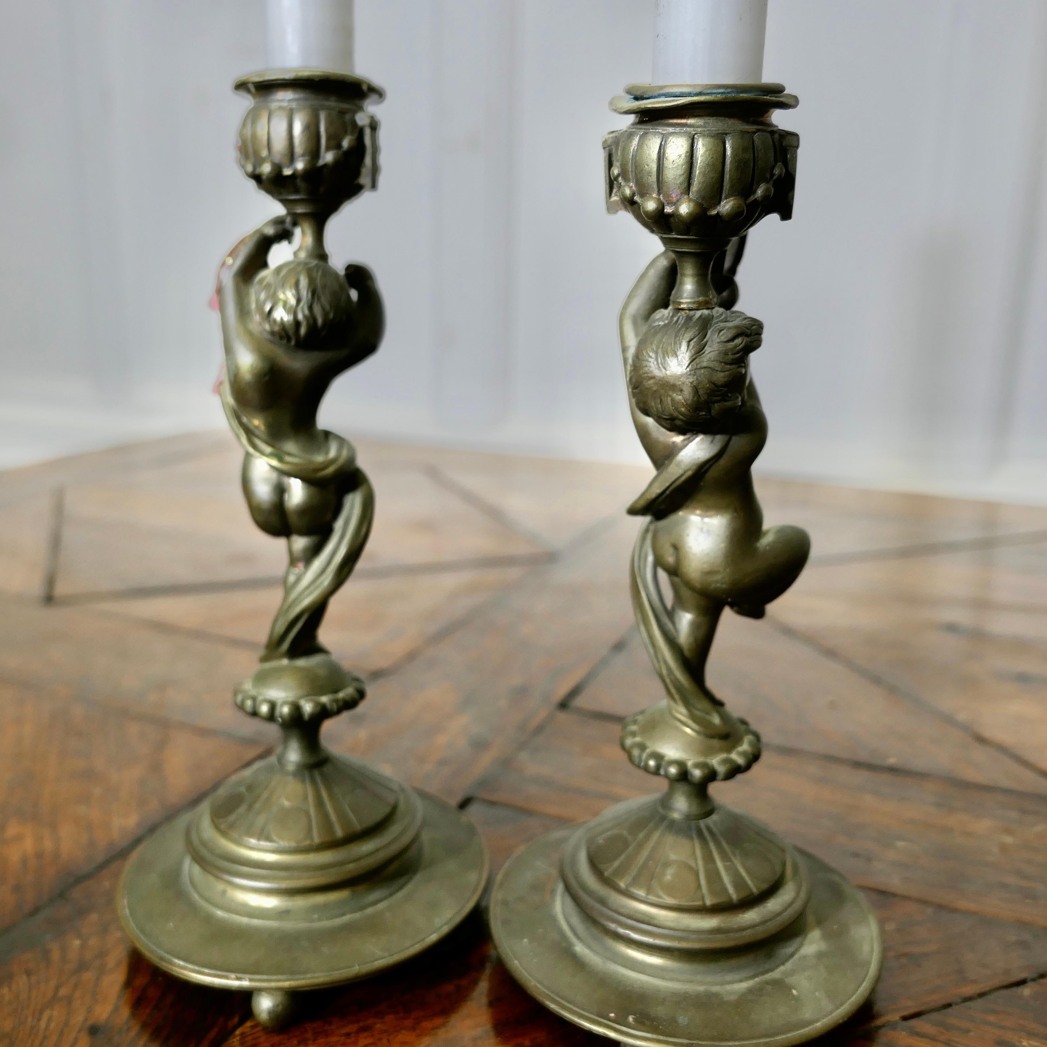 A Pair of 19th Century Brass Candle Sticks with Dancing Cherubs For Sale 2