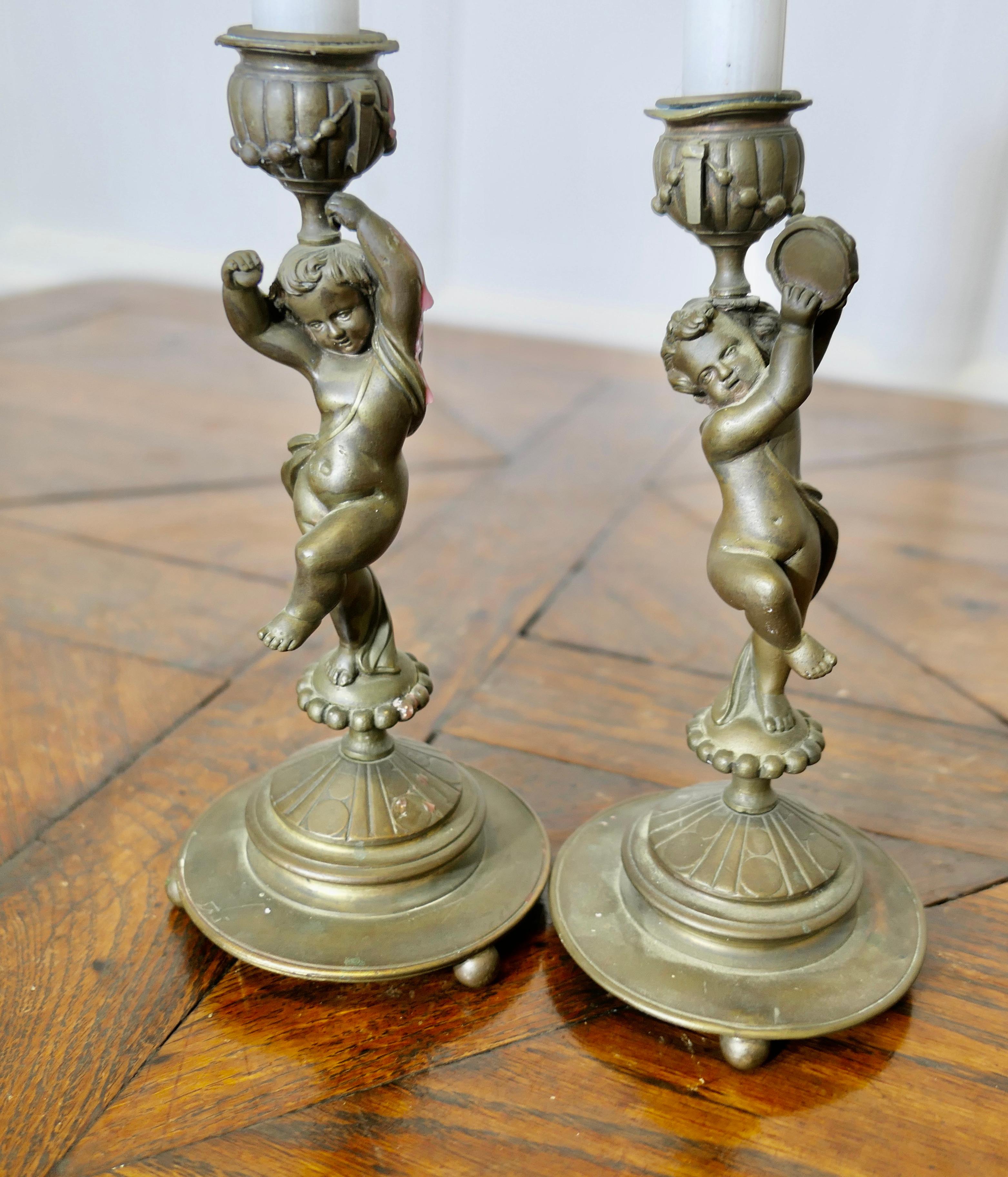 A Pair of 19th Century Brass Candle Sticks with Dancing Cherubs For Sale 3