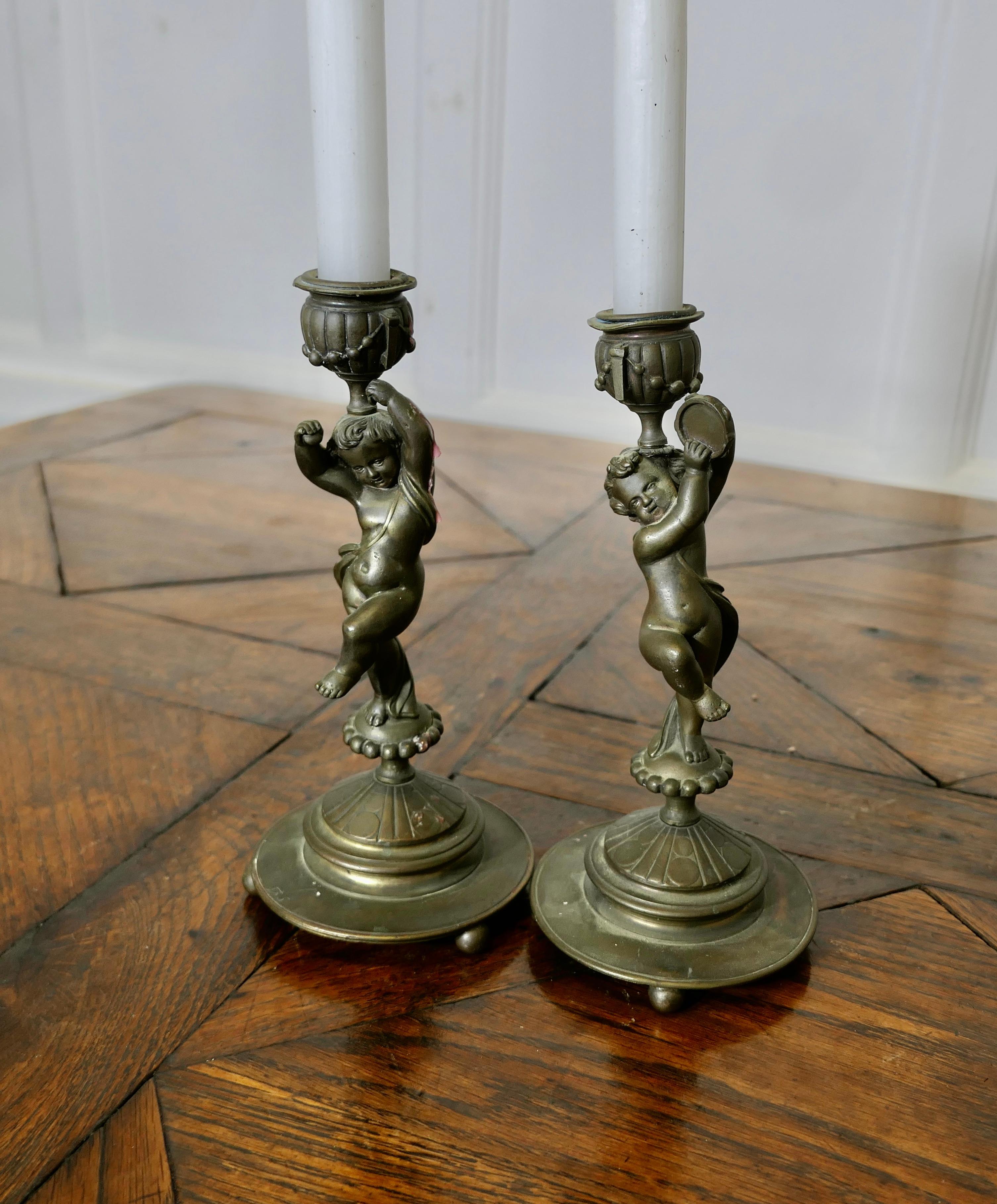 A Pair of 19th Century Brass Candle Sticks with Dancing Cherubs For Sale 4