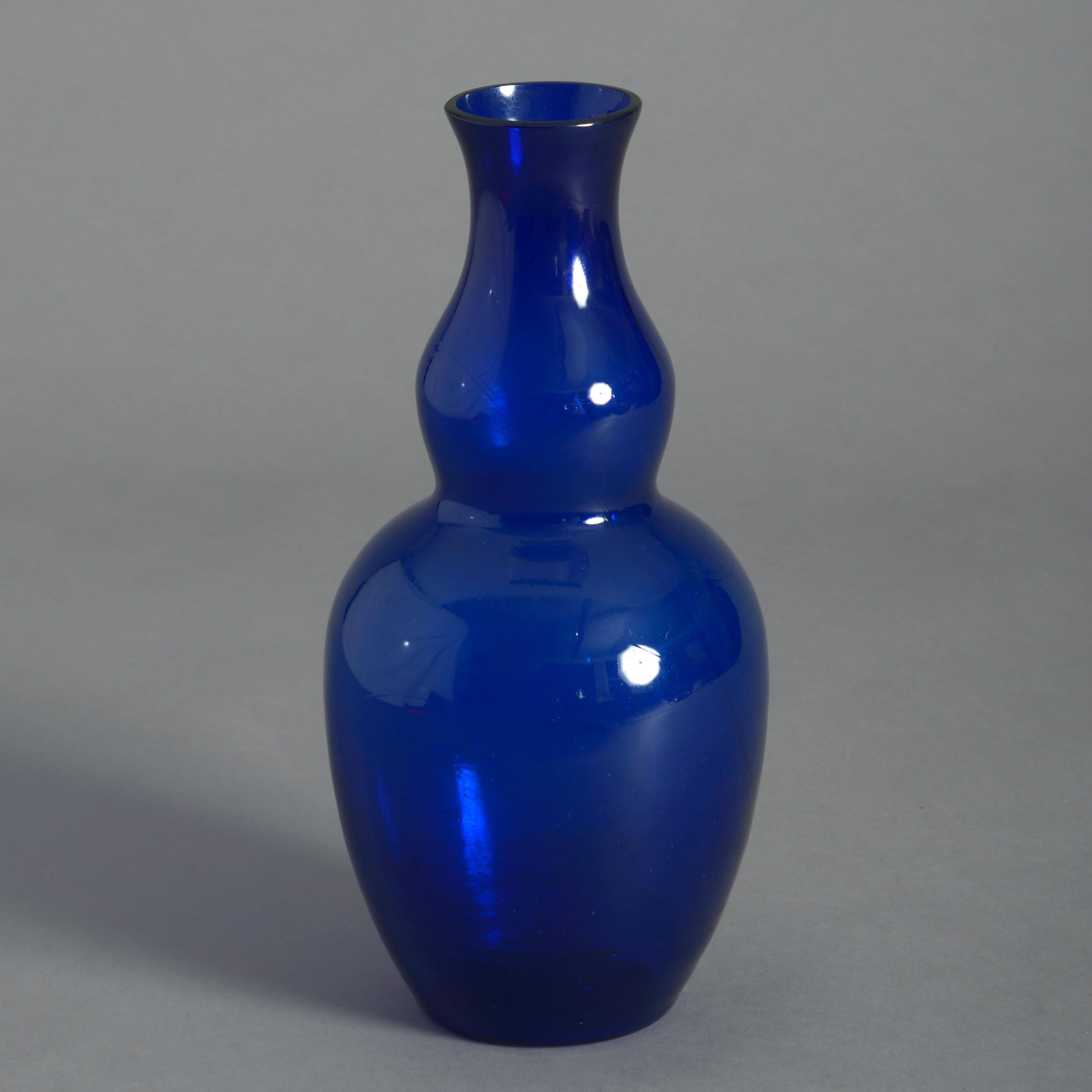 A pair of late 19th century Bristol blue glass vases, the bodies having shaped necks and bulbous bases.