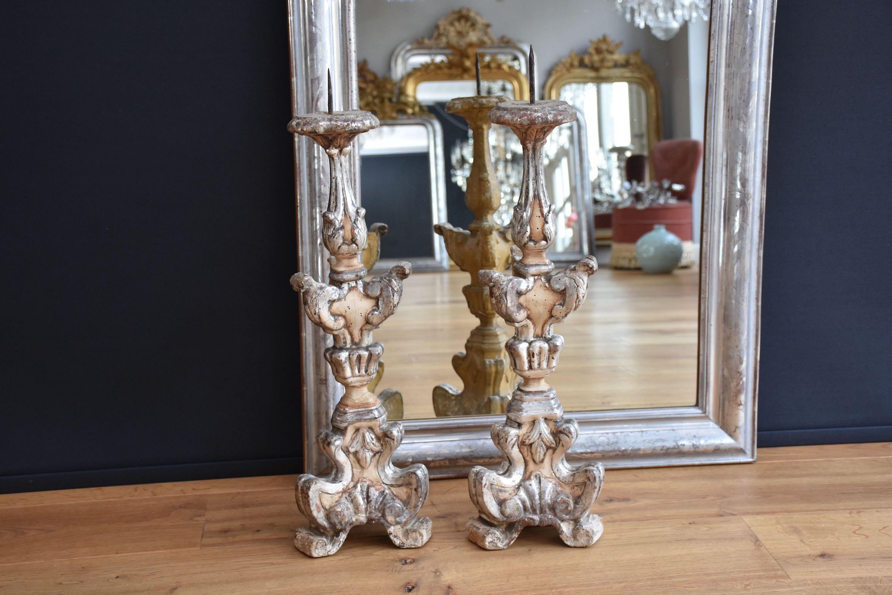 A beautiful pair of original carved and gilded wooden Italian torcheres/ pricket sticks.
The torcheres are in crème colour and have original silver leaf gilding.
Silver-leaf finish is only in front of the torcheres.
The torcheres date from the 19th