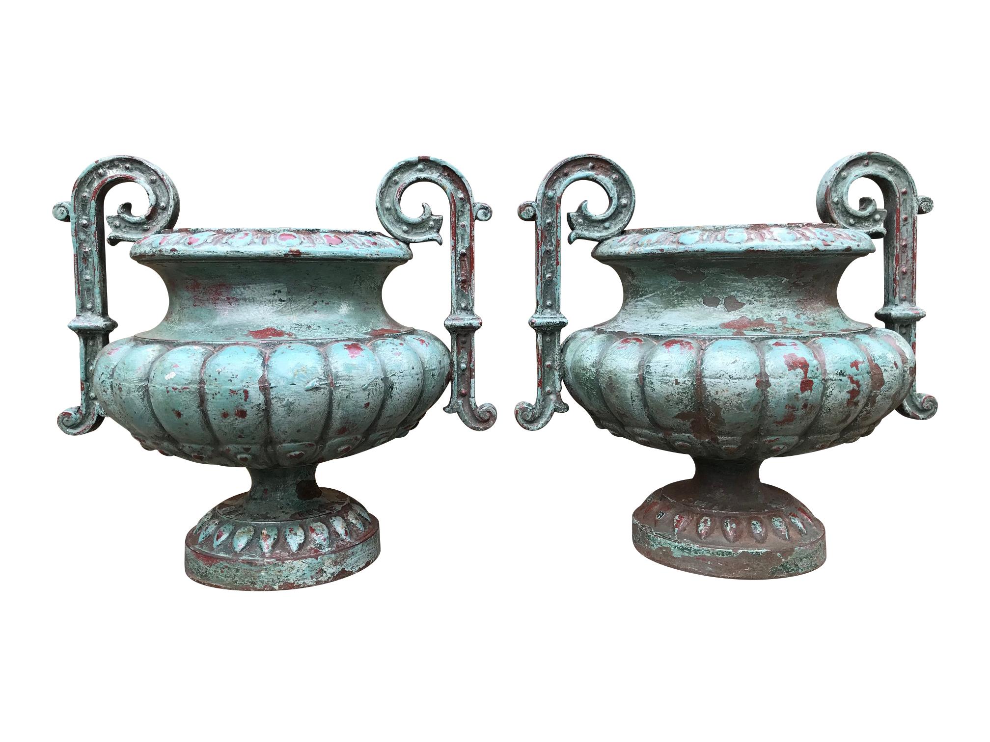 A rare pair of 19th century cast iron urns by Faure a Revin. Antoine Theodore Faure set up his foundry in 1854 in Revin in the French Alps

Famed for producing stoves, this unusual pair of urns are a rare sight. With layers of old paint with