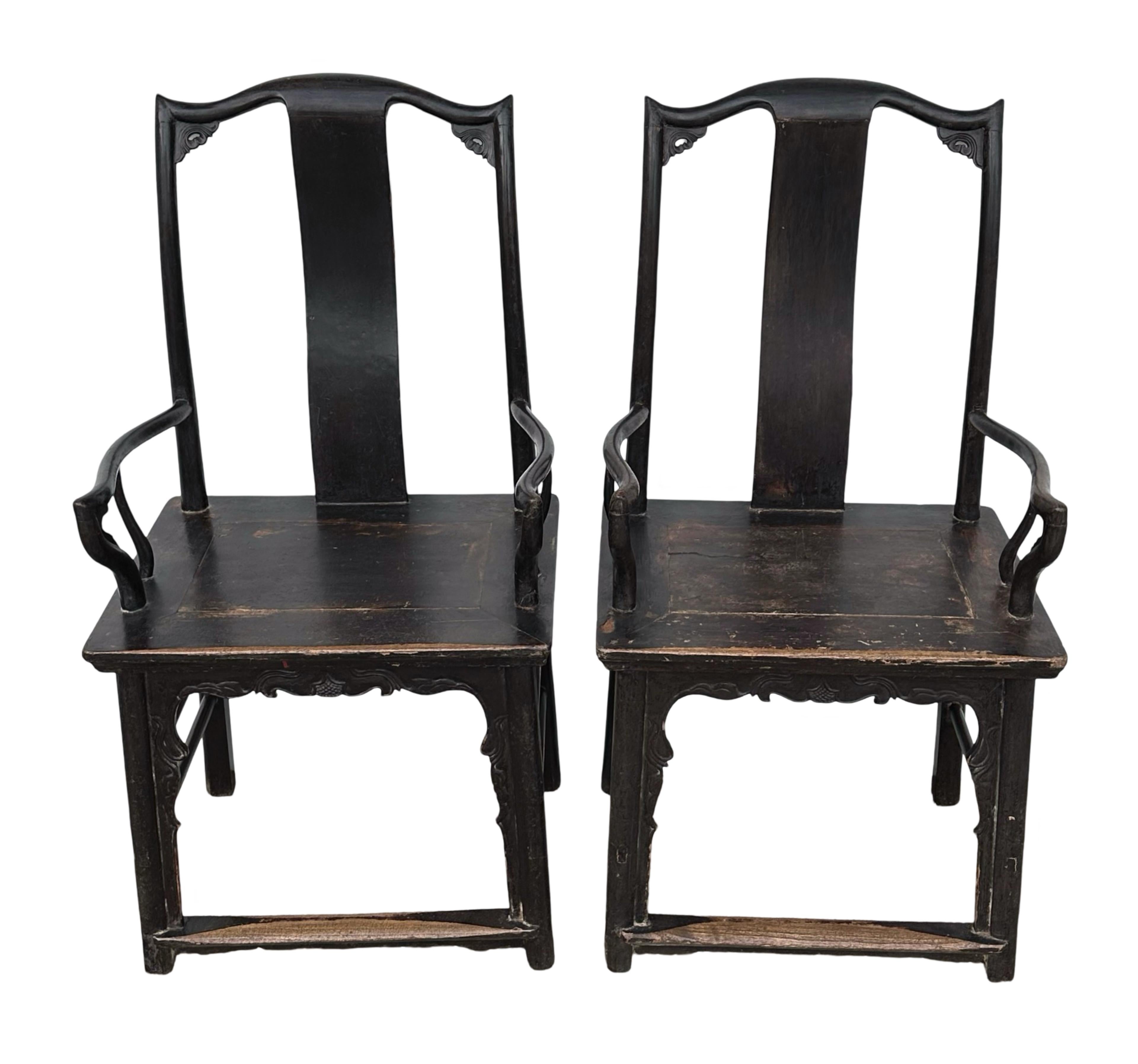 A pair of black lacquered Ming-style official hat's chair from Shanxi province. The origin of the name is because the crest rail at the top of the chairs resembles the winged hats of government officials. The slight angle at the top also makes it