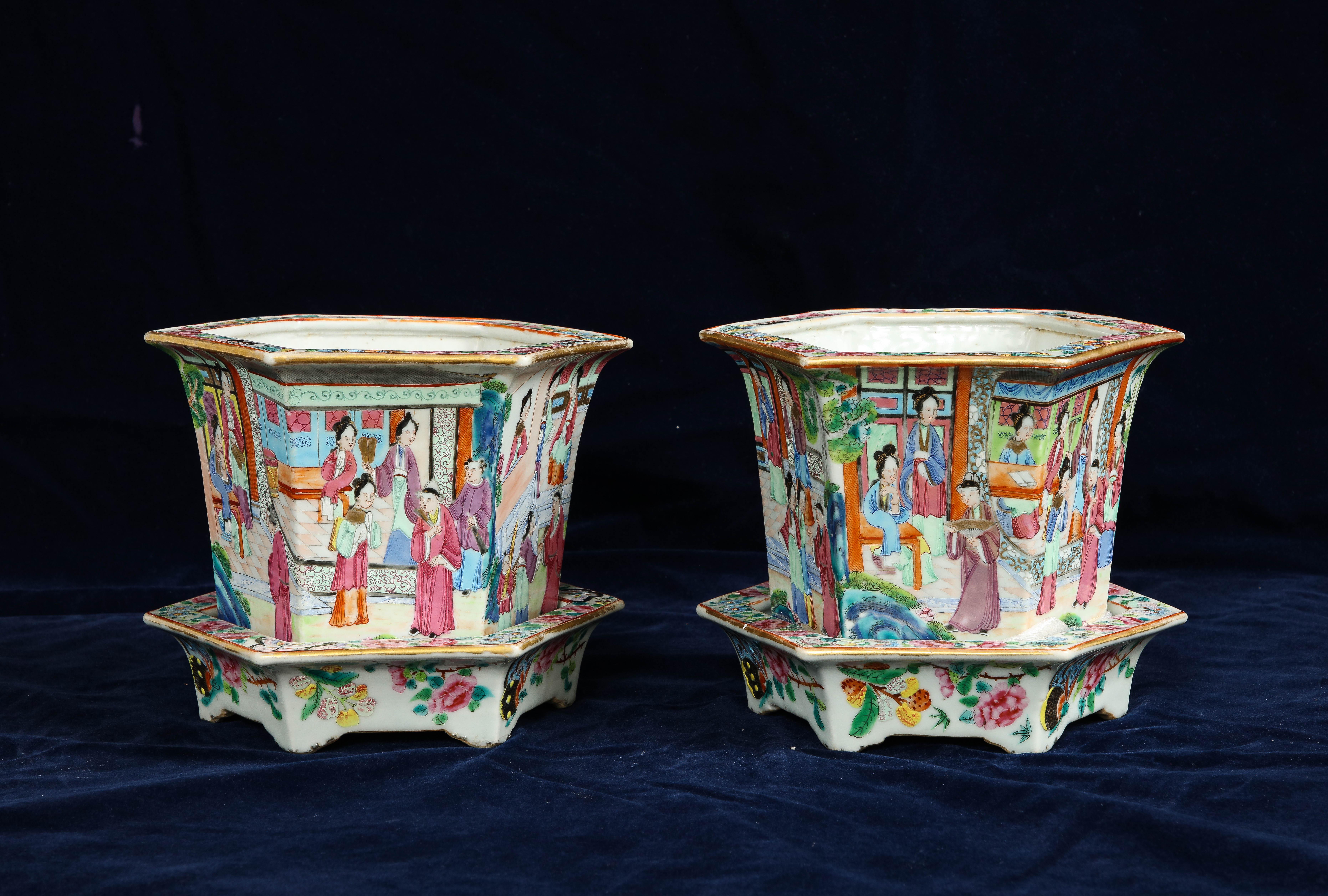 A Pair of 19th century Chinese Rose Medallion Hexagonal Planters with Stands. Each is of an unusual hexagonal form with a beautiful array of rose medallion hand-painted decorations of court ladies in the Imperial palace tending to their righteous