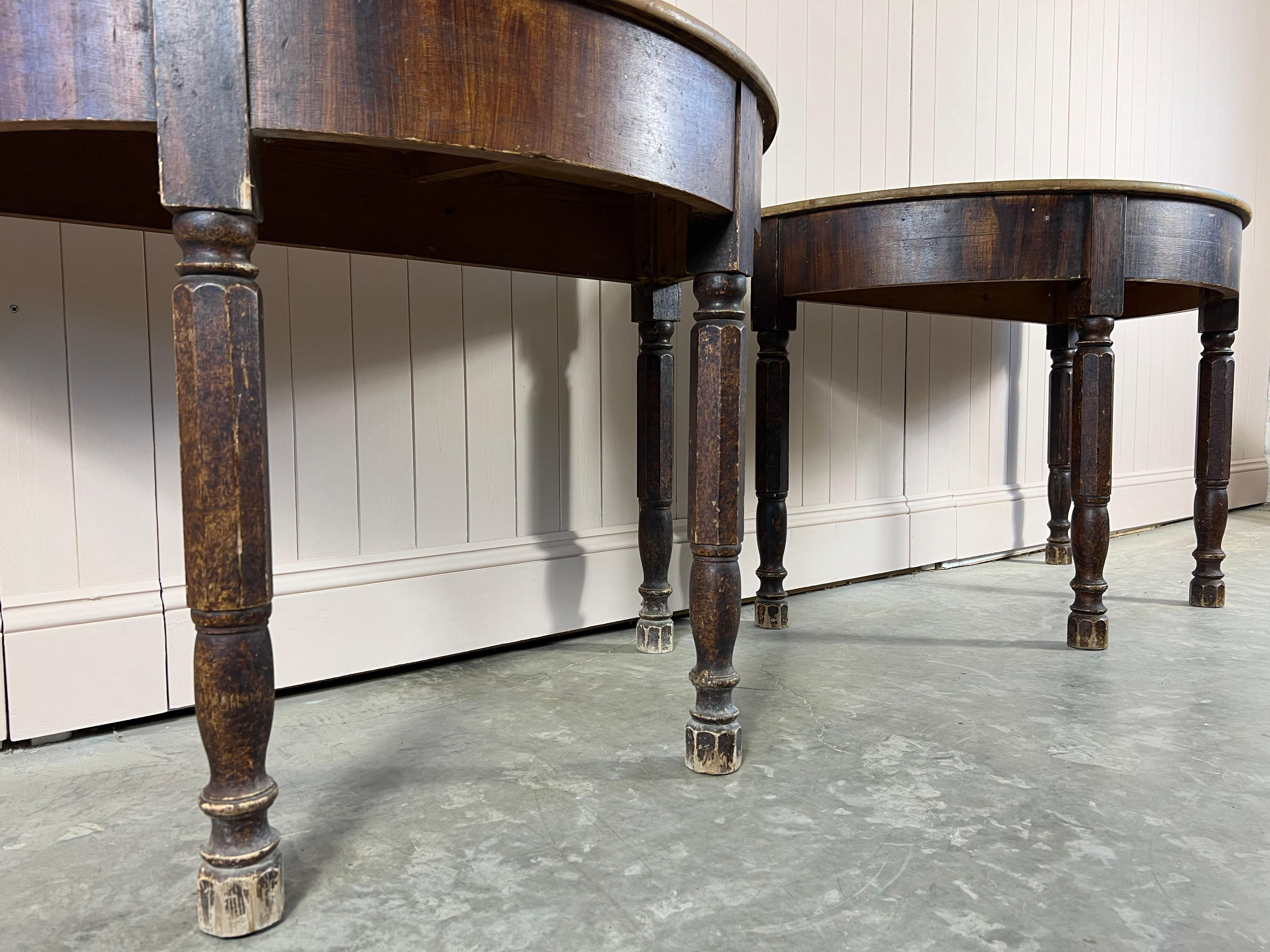 Sourced on the West Coast of France near Bordeaux this pair of antique Demi-Lune tables are mid 19th Century.

We were very drawn to the shape of the legs and the overall natural patina of these painted side tables.  Other than waxing the pine tops