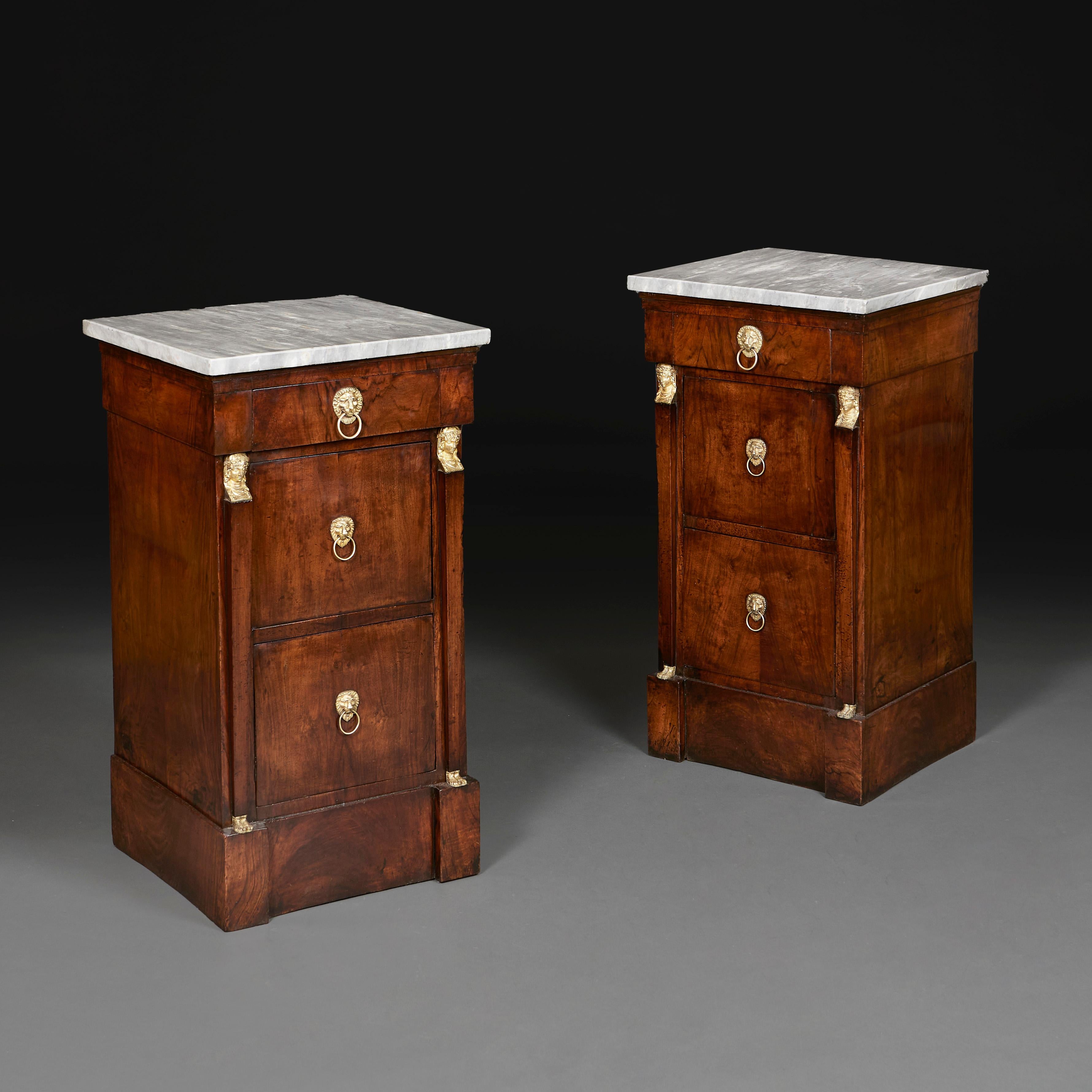 France, circa 1860

A pair of mid nineteenth century Empire bedside cabinets, with original grey marble tops, with ormolu Egyptian caryatids, opening with two drawers and one cupboard door to the front, with ormolu lion mask handles. 

Height