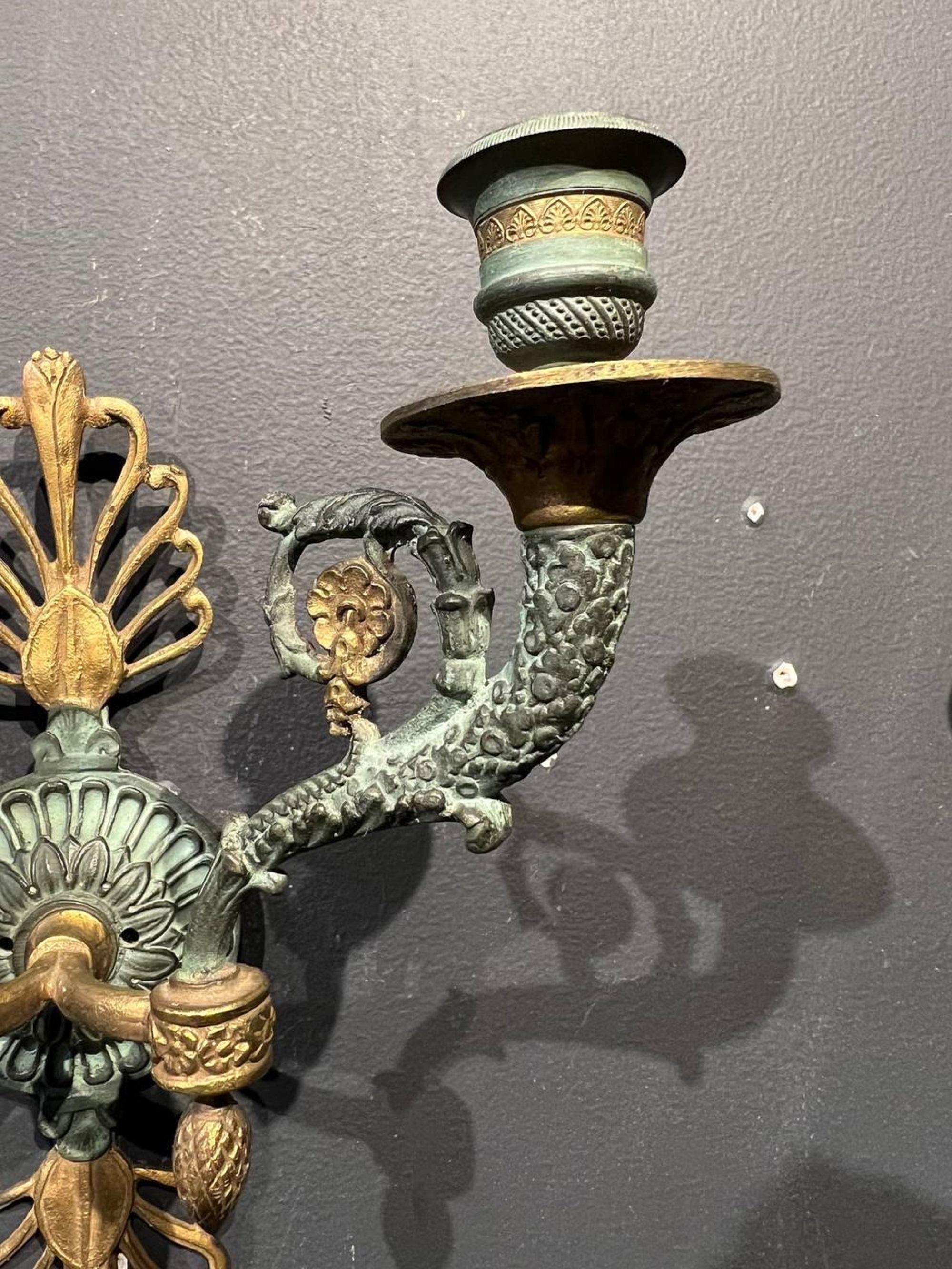 Beautiful pair of 19th century empire sconces with green patina finish.

Dealer: G302YP.