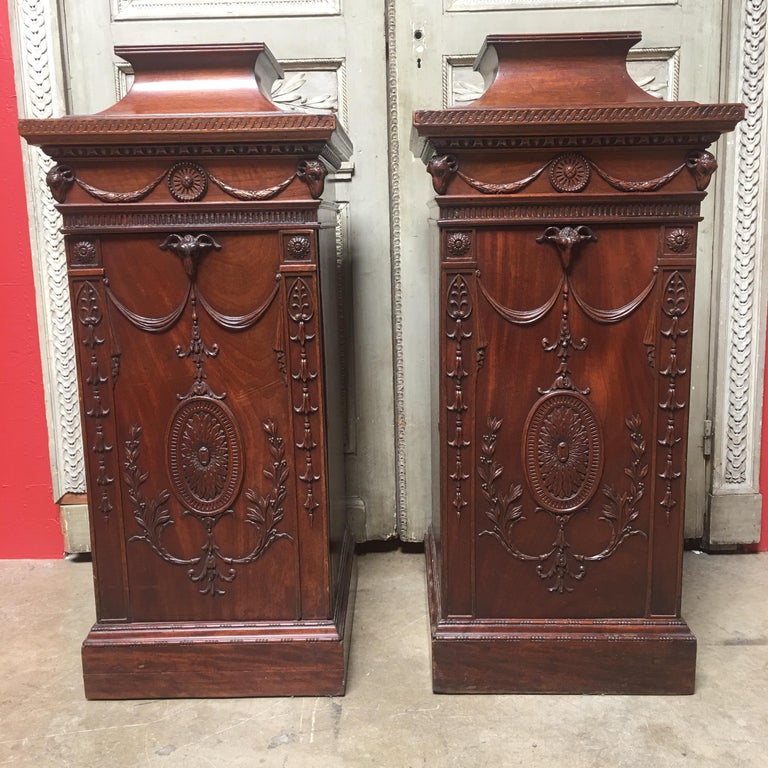
This pair of 19th Century George III style pedestal cabinets are crafted from mahogany in a distinctly Classical manner. Each cabinet is rectangular in shape, standing on a stepped base. Each cabinet features a large cupboard, opening to a single