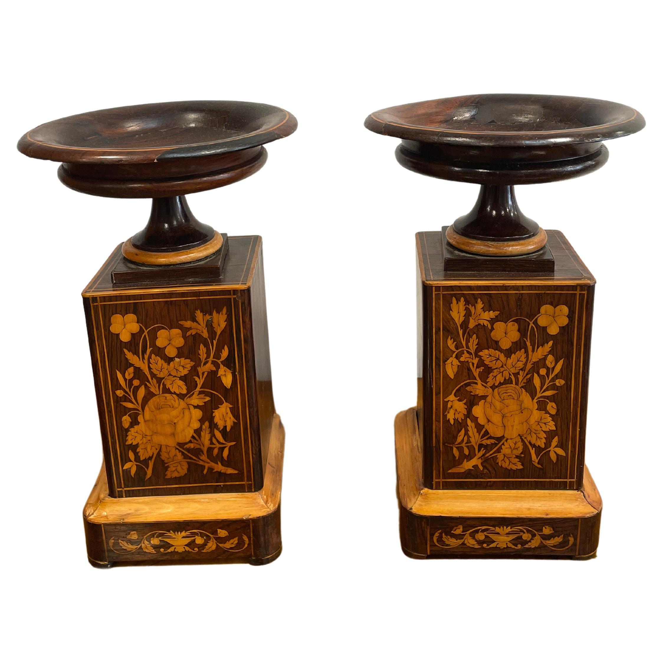 Explore these exquisite French antique vases from 1830, designed as companion pieces for a mantel clock. Crafted with a mahogany veneer and adorned with a stunning maple flower marquetry on the front, these wooden vases emanate timeless