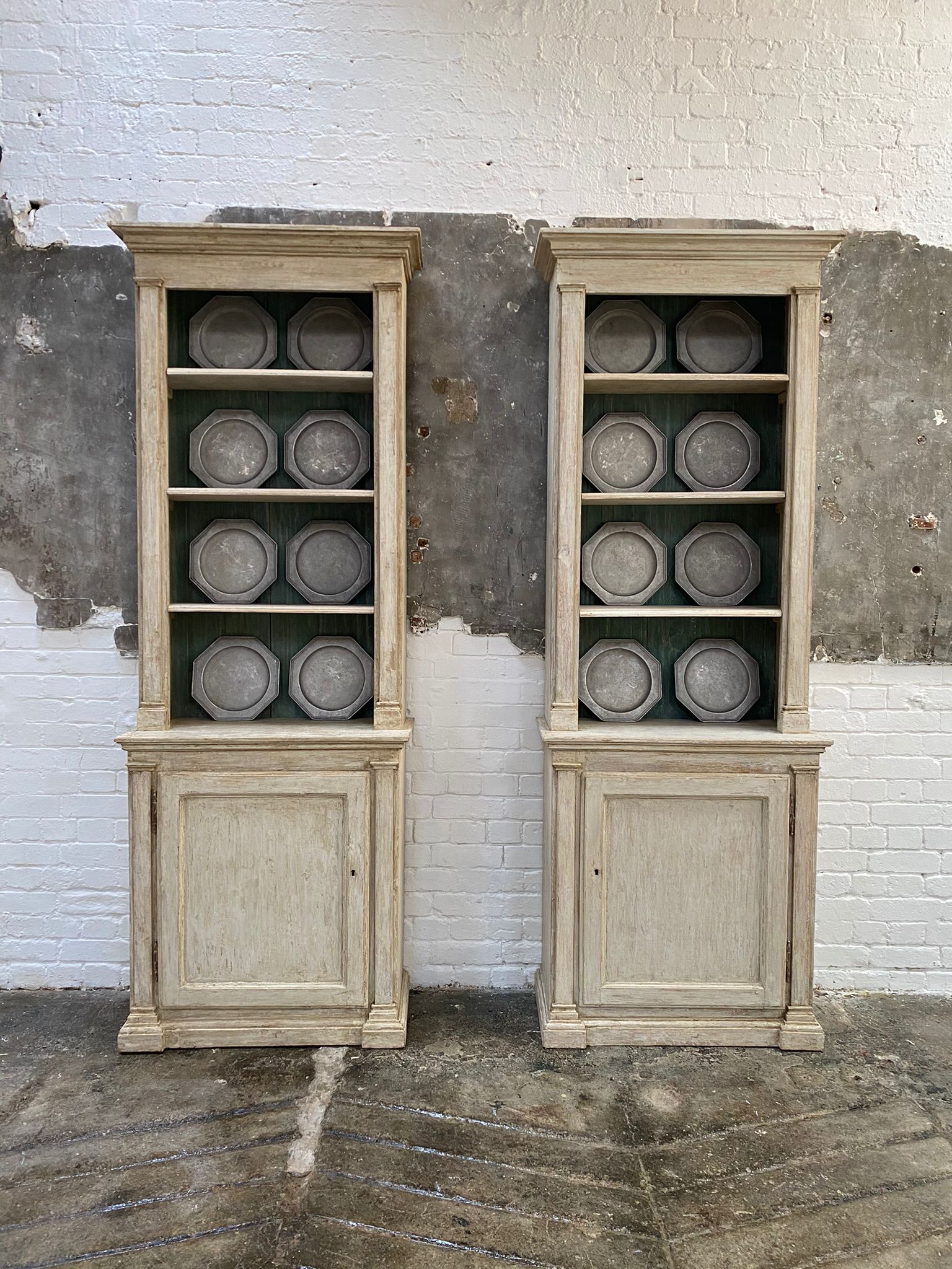 A wonderful pair of tall bookcases, French, dating from the late 19th century. 
The bookcases have four shelves that are removable. The cupboard base with single shelf enclosed, has the original lock and keys. 
The original paint finish has been