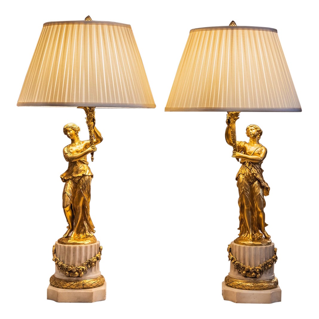 A pair of 19th century French gilt brone lady lamps with Carrera marble bases For Sale