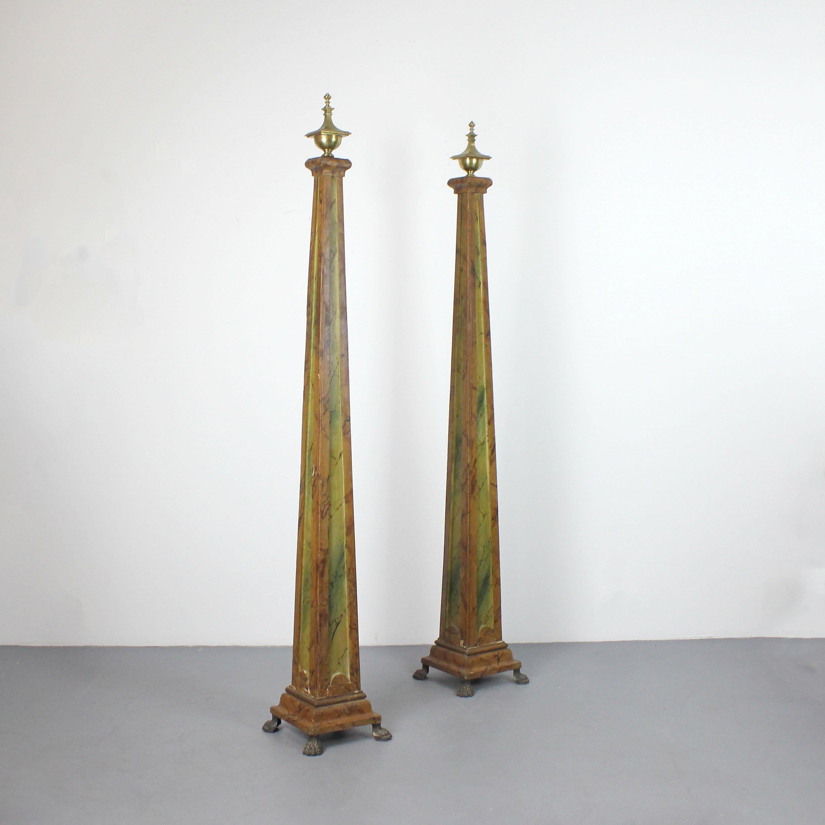 A pair of 19th-century French obelisks, made of polychrome wood to look like marble, with gilded bronze claw feet and finials.