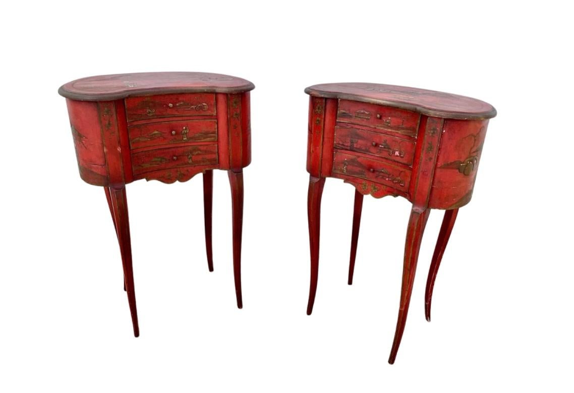 A pair of 19th century English red Japanned/Chinoiserie side tables, trimmed in gold. These kidney-shaped tables have three small drawers and stand on four tall tapered legs.