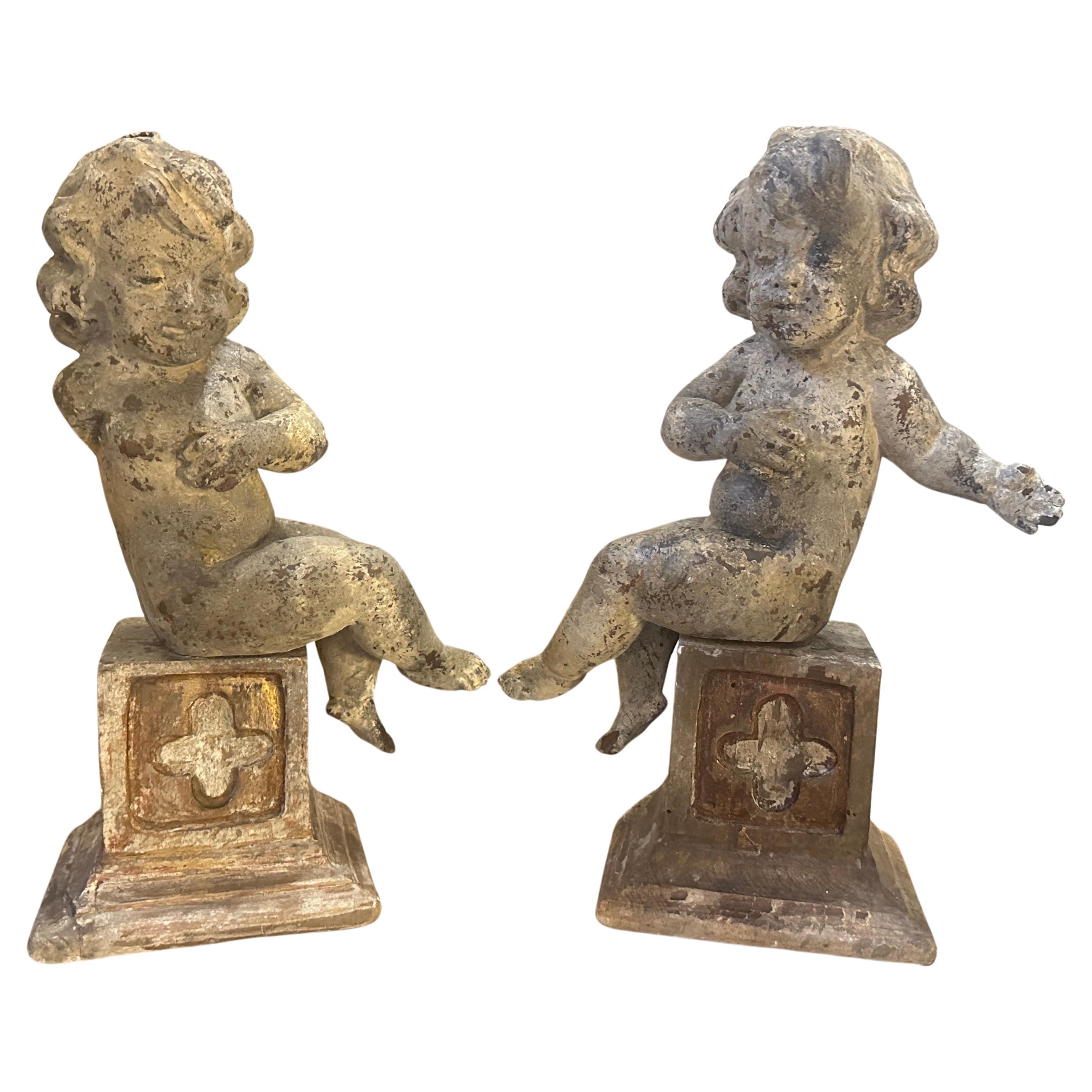 A pair of  19th Century Italian Wooden Putti Mounted on 18th Century Bases