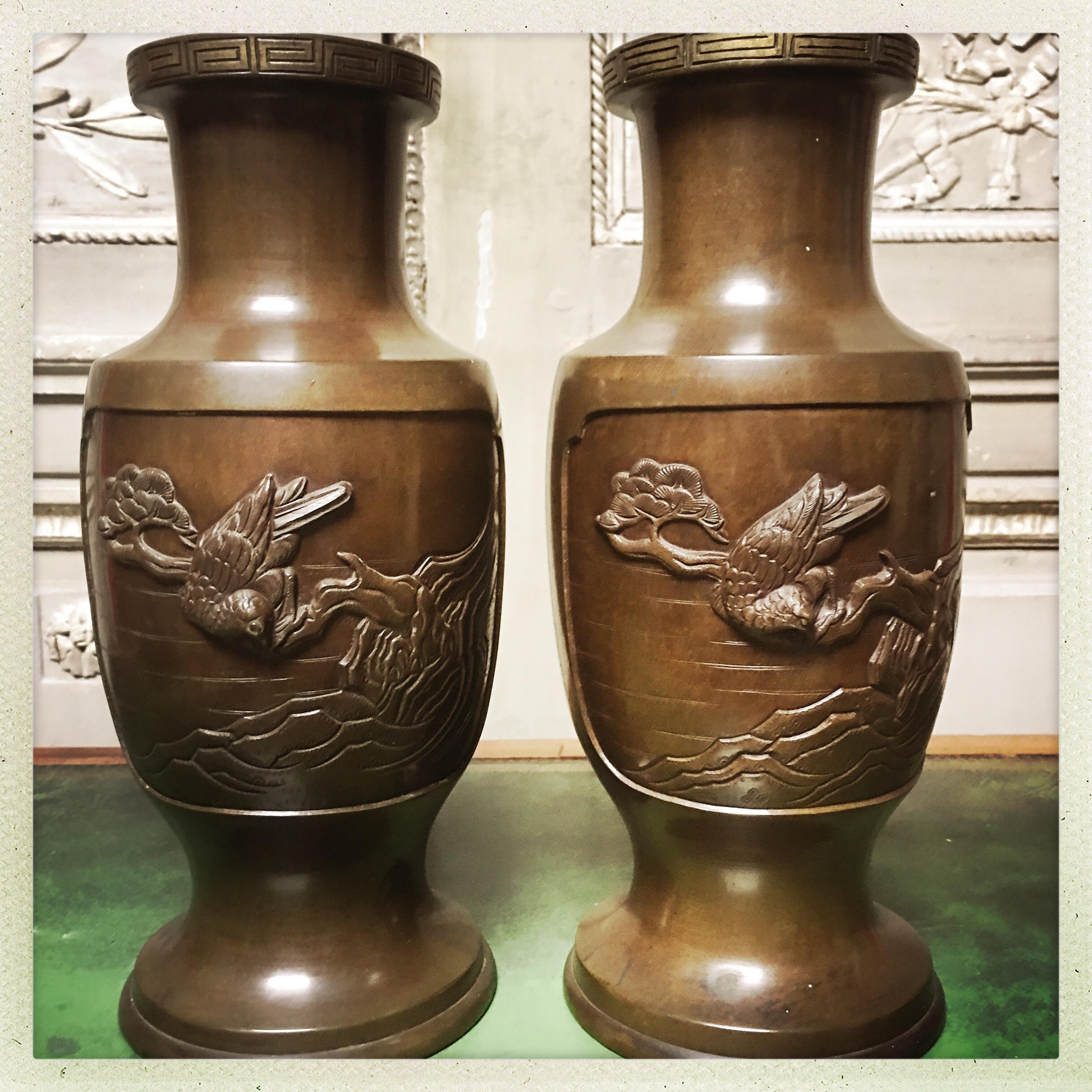 A pair of Japanese bronze vases depicting scenes with different birds.
These would make a wonderful pair of lamps.