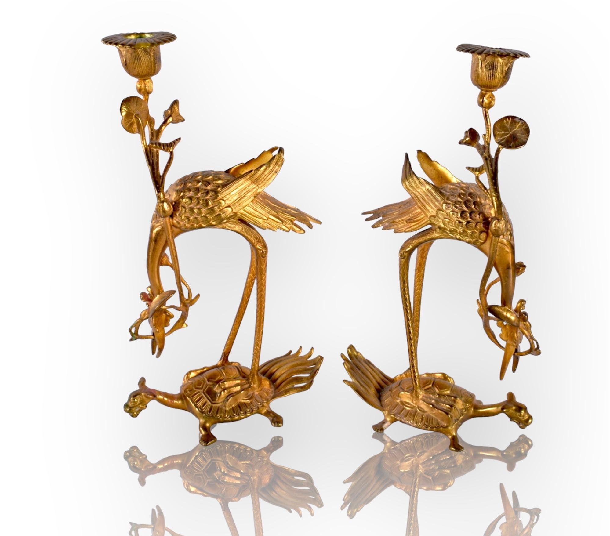 A High Quality Pair of Japanese gilt bronze candlesticks figures of a crane standing on the back of a turtle, a lotus plant in its beak forming the candle sconce.


Meji period, late 19th century


Size: H 30 cm


In good condition commensurate with