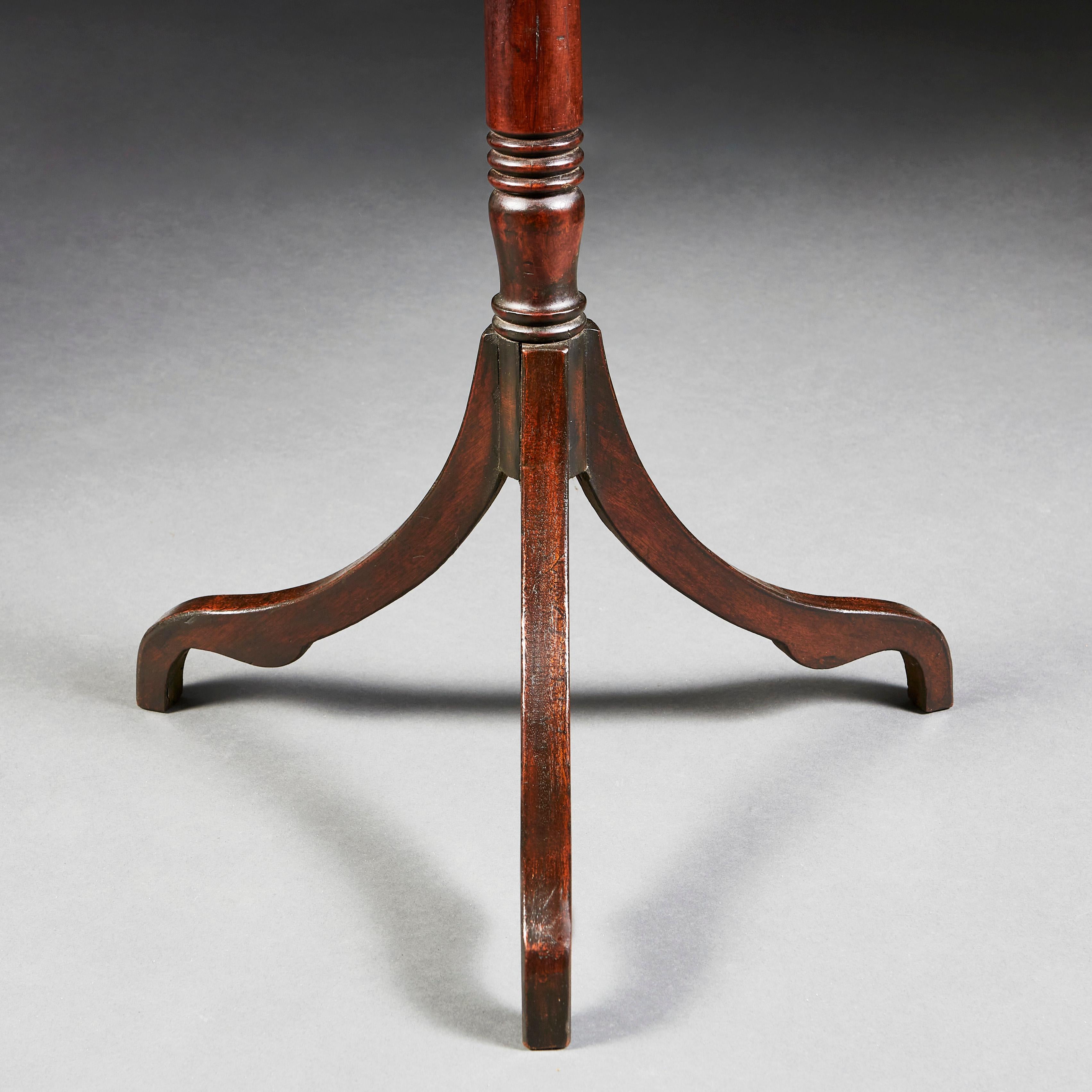 A fine pair of mid-19th century mahogany tripod tables, the square tops with canted corners and brass edges, all supported on a tripod base with splayed feet.
 
  