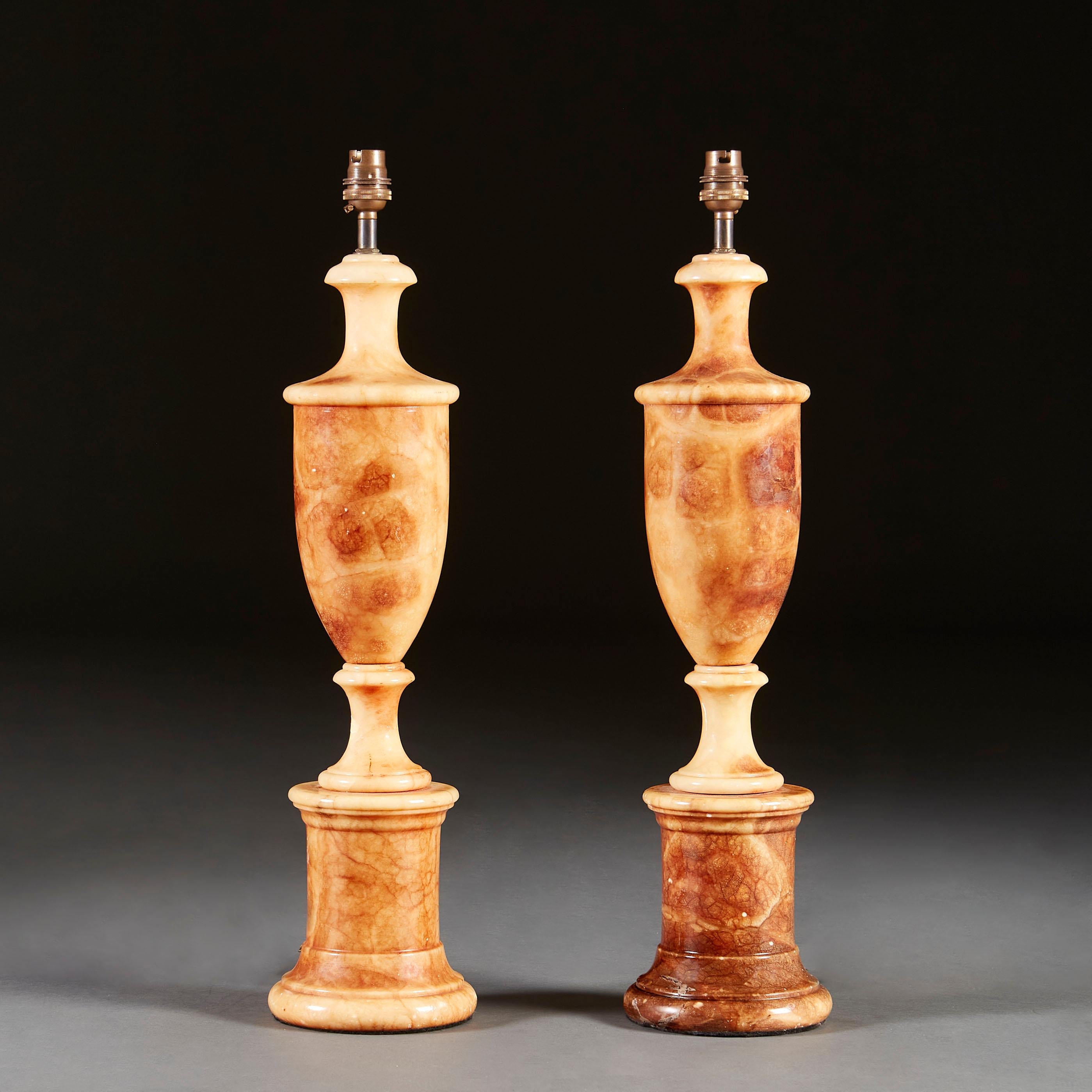 A pair of late nineteenth century marble column lamps of turned urn form, on circular plinth bases.

Please note that these lamps are currently wired for the UK, and that the lampshade is not included. Please enquire about rewiring services.