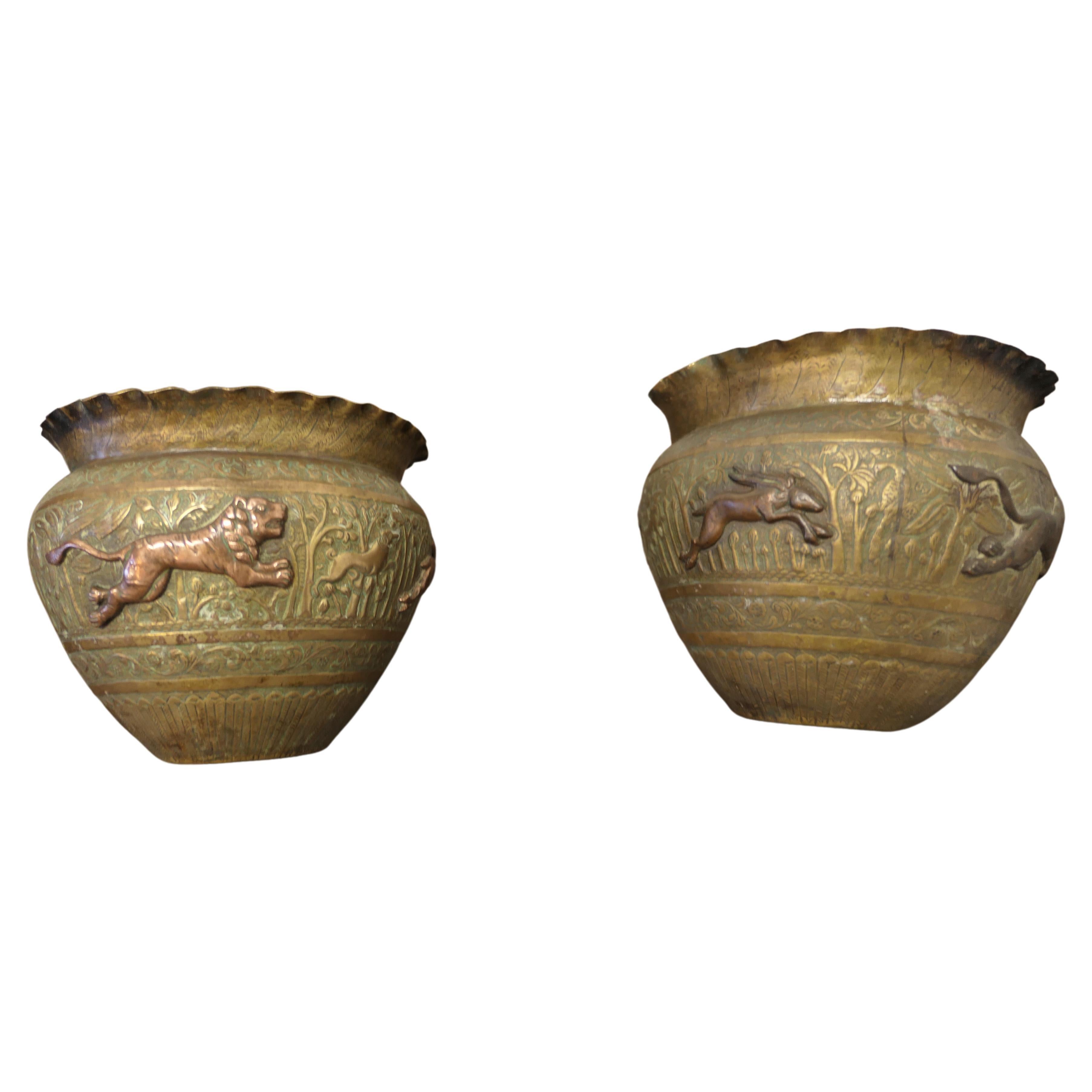 A pair of 19th century North African brass and copper Jardiniere pots

These are superb hand made pieces, they are embossed and decorated with lively copper animals 
The pots have a waved collar
The pots are wonderful looking pieces with natural