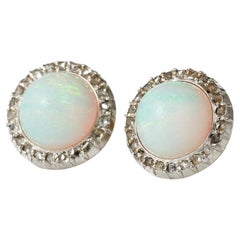 Antique A pair of 19th century opal and diamond cluster earrings. Silver over gold.