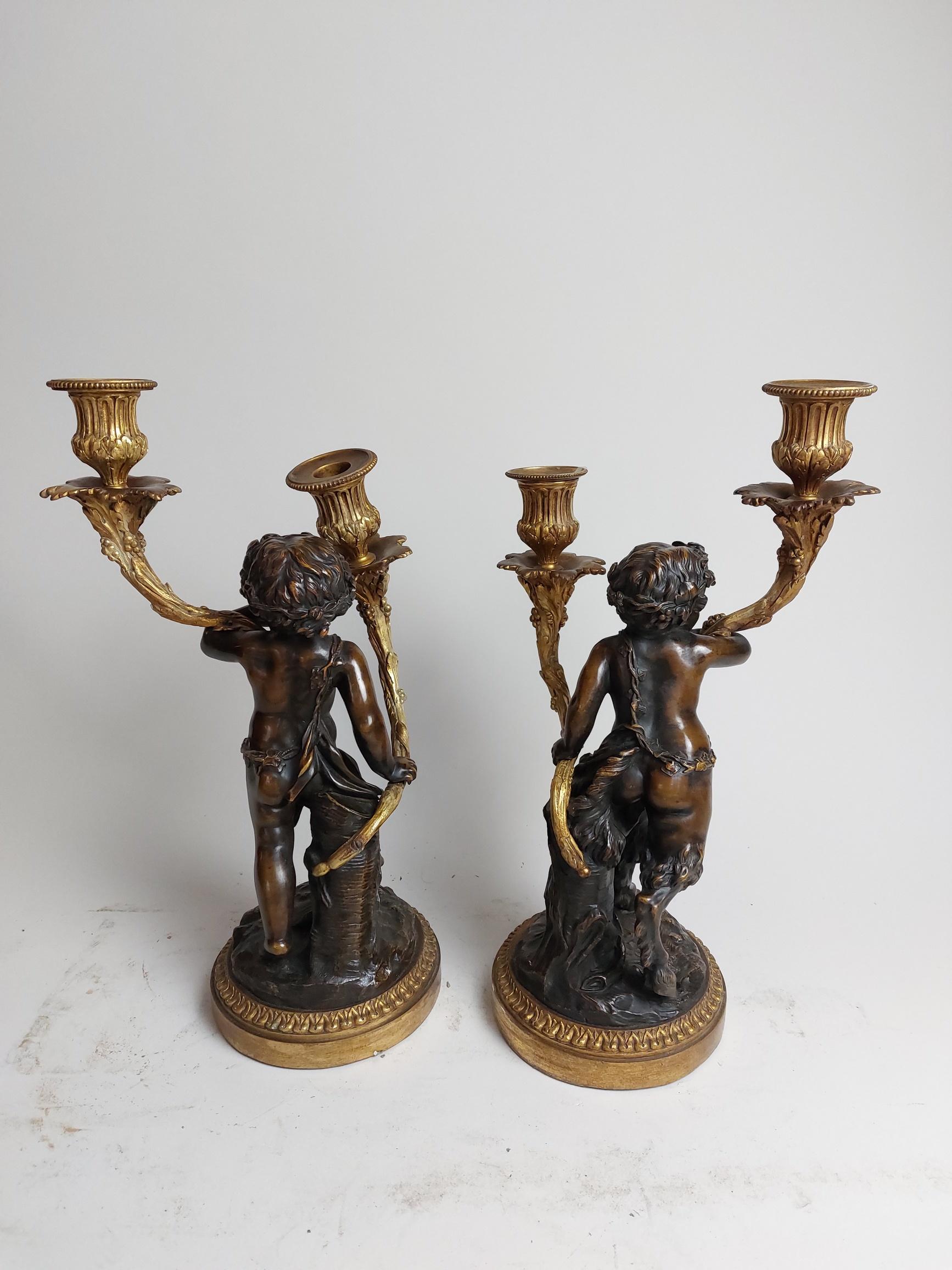 Cast Pair of 19th Century Ormolu Candlestick Holders Held by Bronze Fawns/Cherubs For Sale