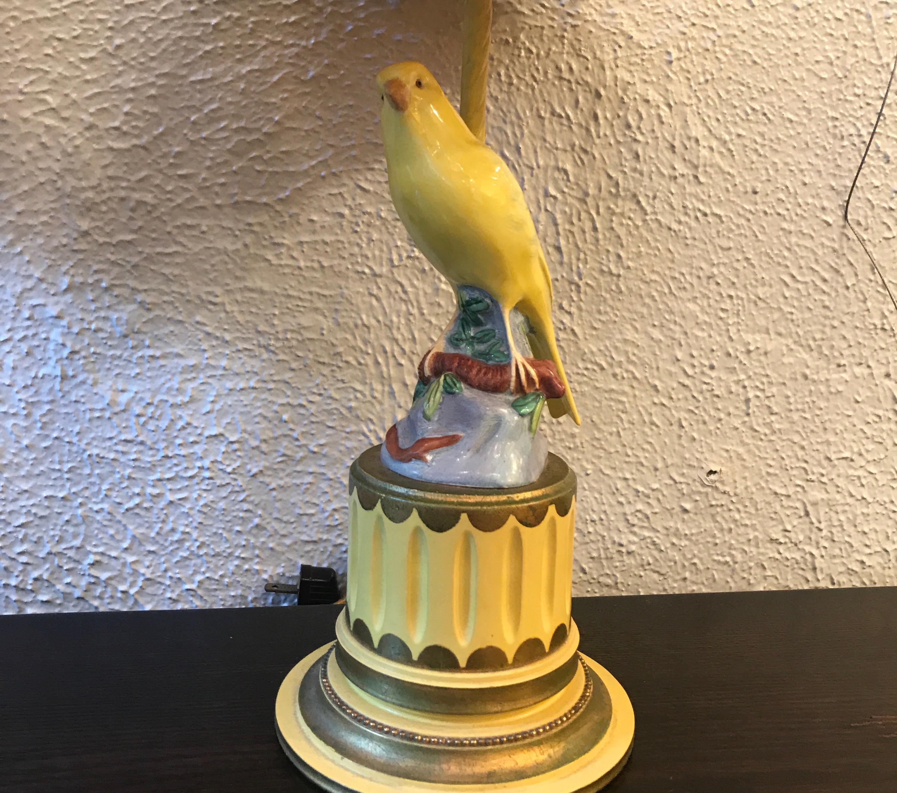 Whimsical pair of German porcelain canary birds from the 19th century now mounted as lamps done in the mid-20th century. The custom painted bases with amazing yellow silk shades. The bases are 5 inches in diameter.