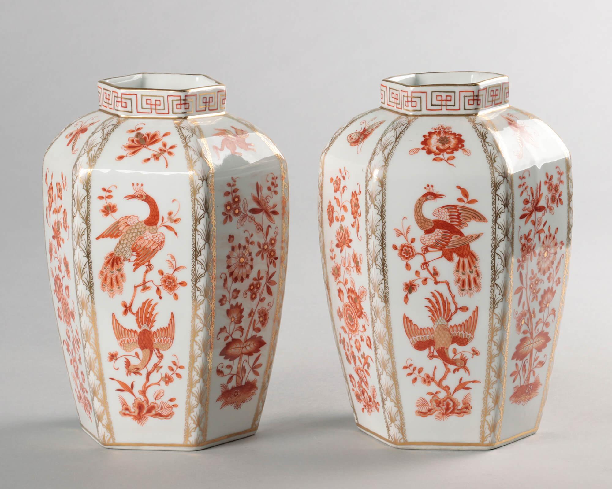 Two beautiful antique porcelain vases from the 19th century by Helena Wolfsohn. The vases are made of white porcelain and decorated with geometric motifs, birds, butterflies, flowers and gold accents. The vases are marked on the bottom