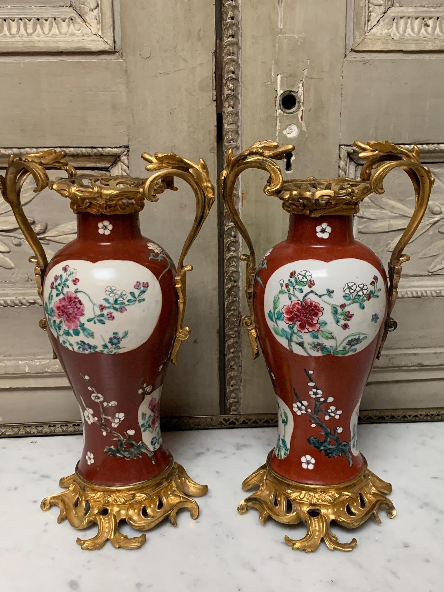 A pair of red Chinese export porcelain ovoid vases probably Qianlong period, with later 19th century Parisian French Louis XV style gilt bronze mounts.

The chinoiserie style was extremely influential in European decorative art at the time this