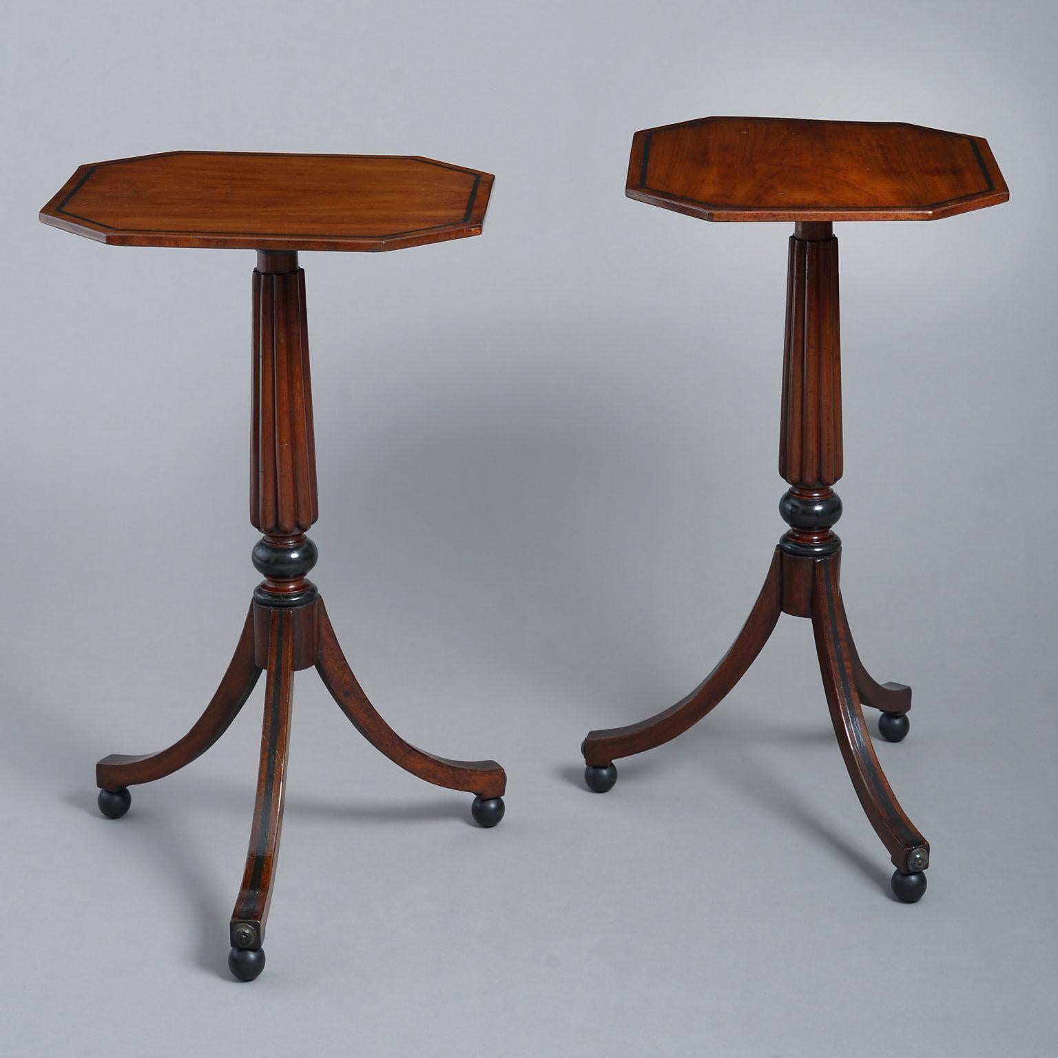 A pair of 19th century mahogany end tables, each having inlaid rectangular tops with chamfered corners and set upon reeded stems, terminating in splayed tripod legs and raised upon ball feet. The tops and bases possibly associated.
          