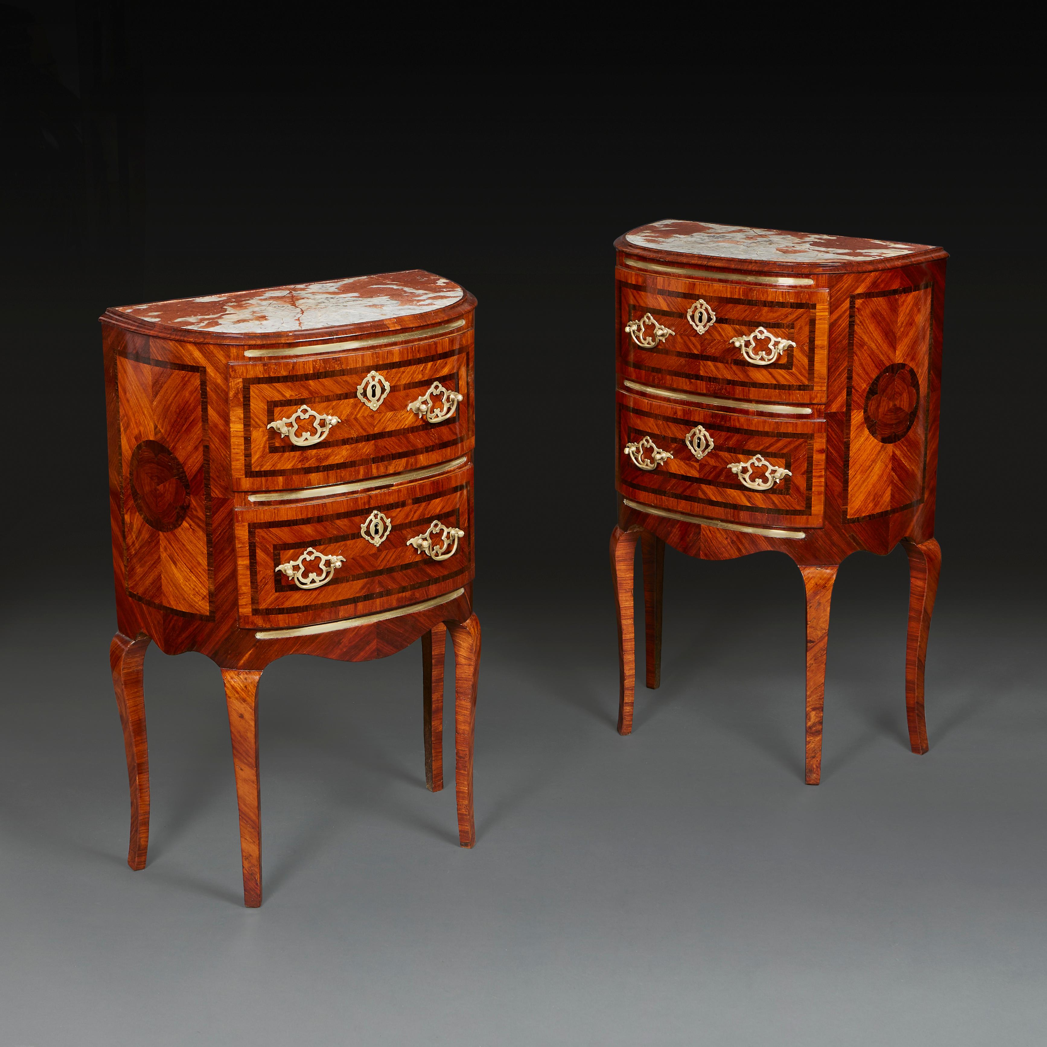 A fine pair of Roman marquetry bedside tables, with inset red and white marble tops, opening with two drawers to the front, with brass mounts, all supported on cabriole legs.