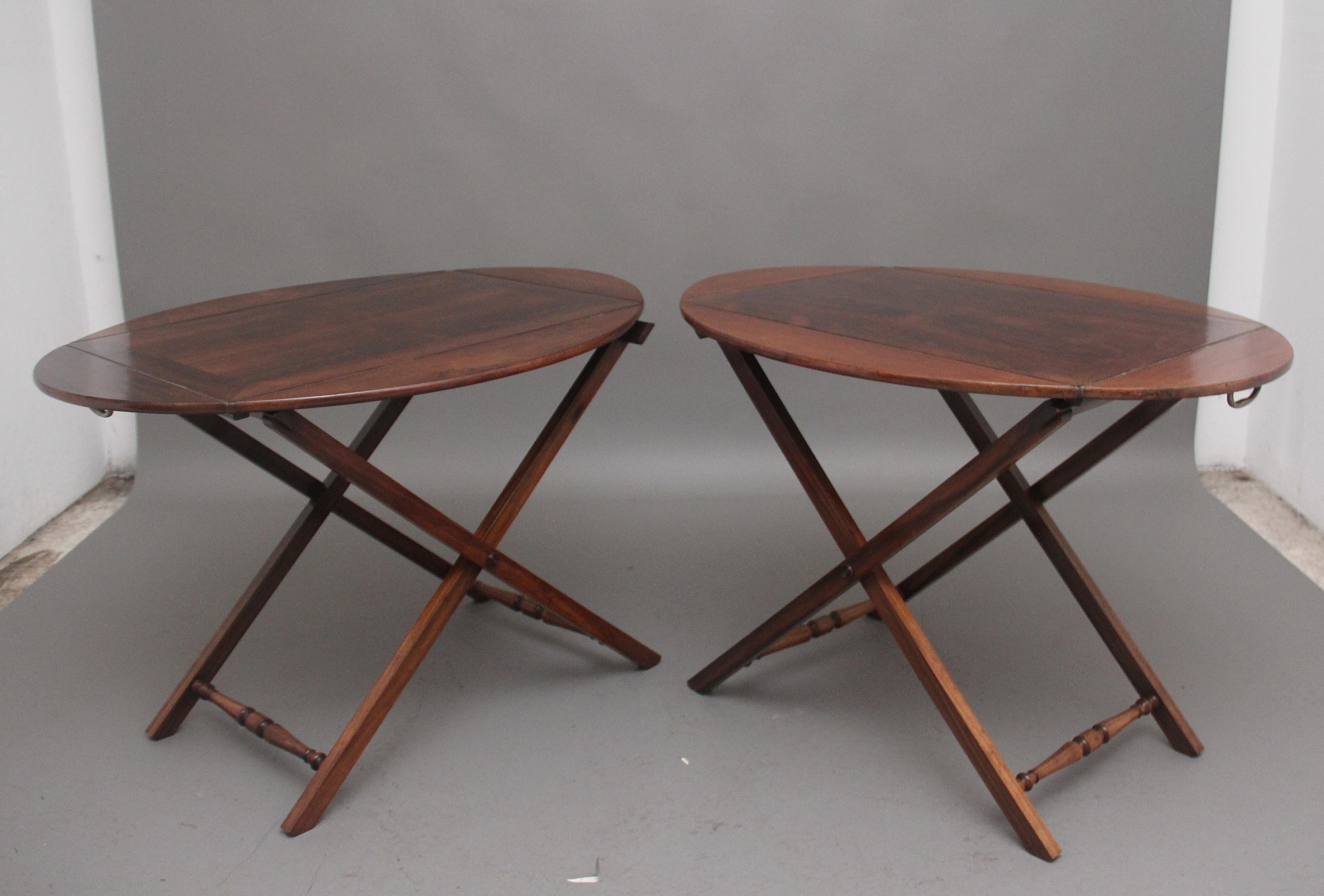 A pair of 19th Century rosewood folding butlers tray on stands of exceptional quality, the rectangular panelled tray has four folding sides with inset brass hinges, either end of the tray having the original brass carrying handles, wonderful