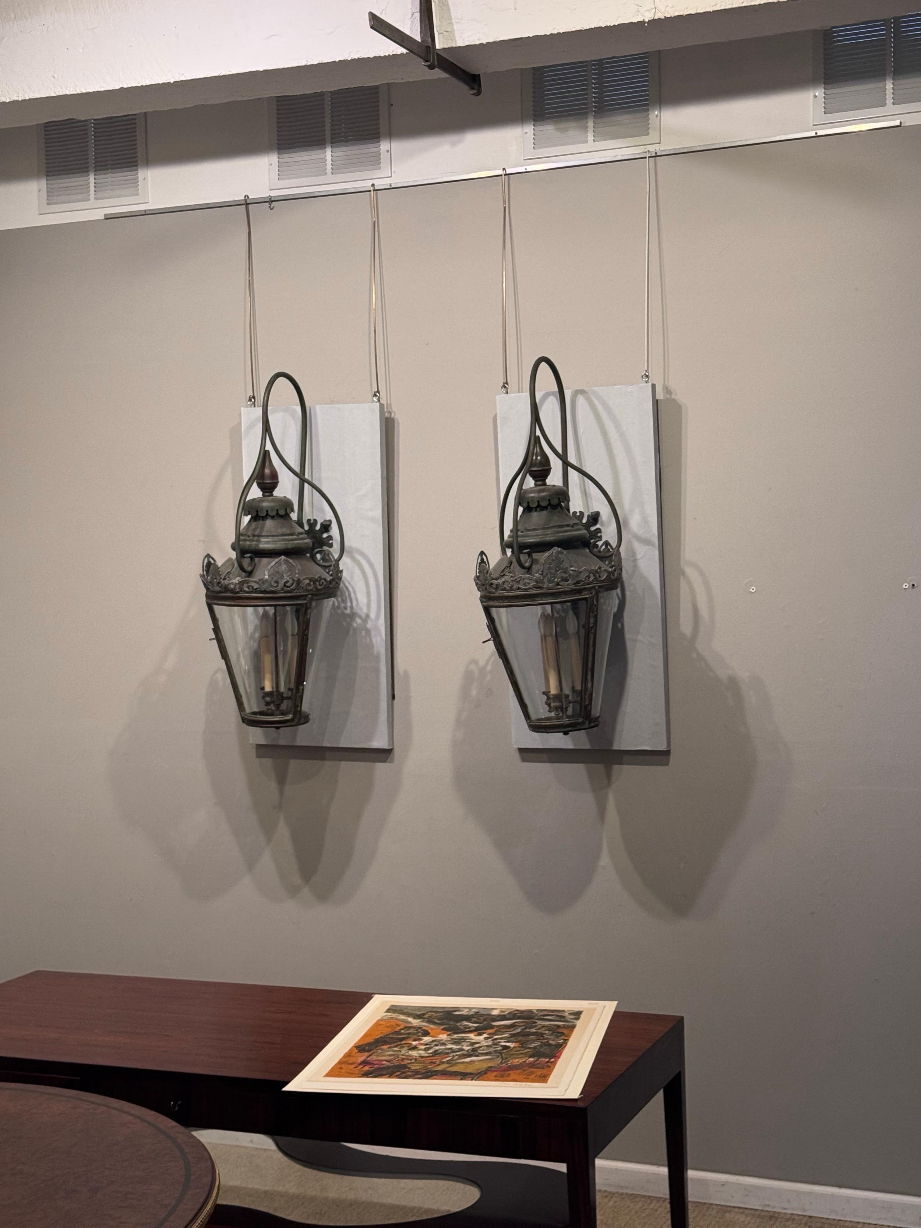 A pair of 19th Century Street lanterns

   These beautiful lanterns originally configured as gas lanterns. Were reworked with new electric fixtures and new wall brackets.  The lanterns have a beautiful patina and the brackets & hardware were
