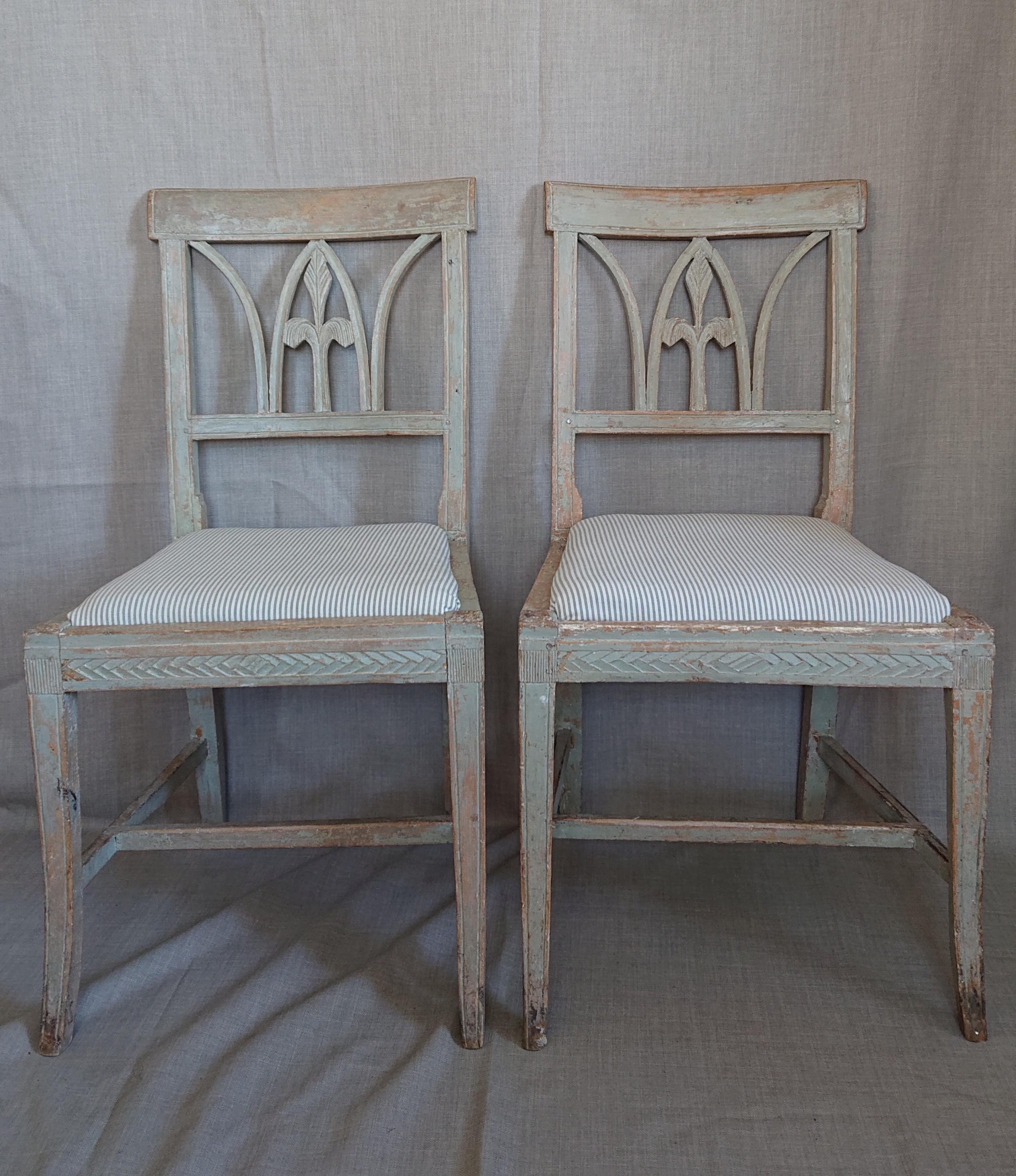 A pair of 19th century Swedish Gustavian chairs from Lindome Halland, Southern Sweden.
 A Very nice and decorative Chair model with a cut lily in the back of the chair.
Nicely cut decor around the chair seat & reeded legs.
The chairseat is