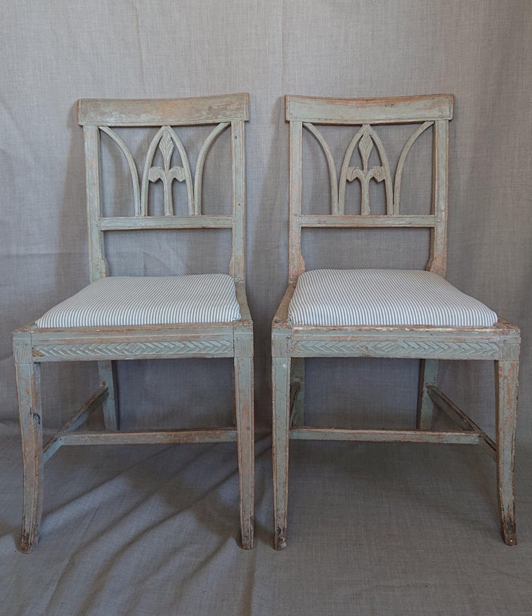A pair of 19th century Swedish Gustavian chairs from Lindome Halland, Southern Sweden.
 A Very nice and decorative Chair model with a cut lily in the back of the chair.
Nicely cut decor around the chair seat & reeded legs.
The chairseat is