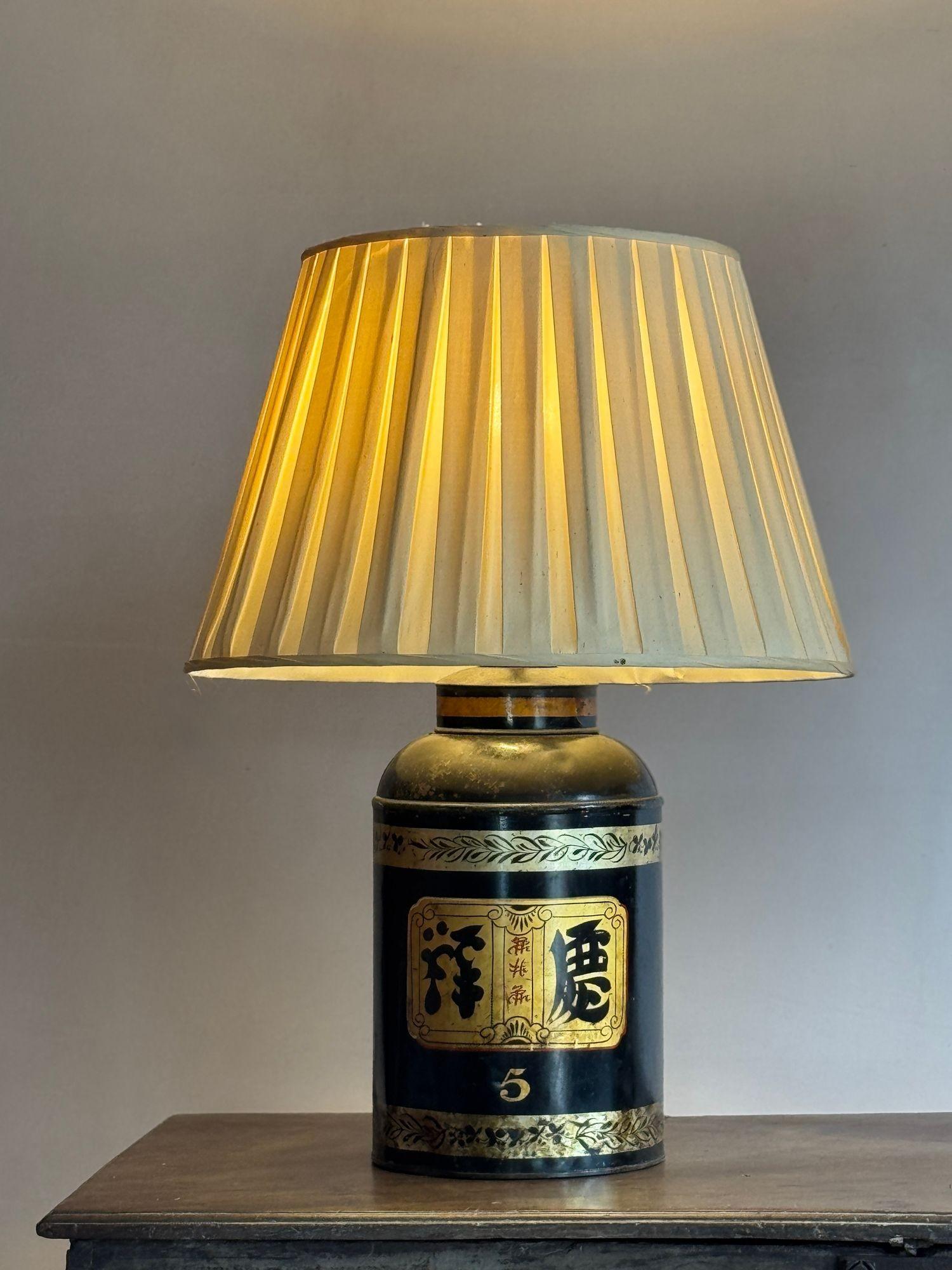 A pair of late 19thC tole tea canisters converted to lamps. The shades (which are a little worn) are included. Dimensions: H 70cm (with shade) 62cm (without)
W 22.5cm