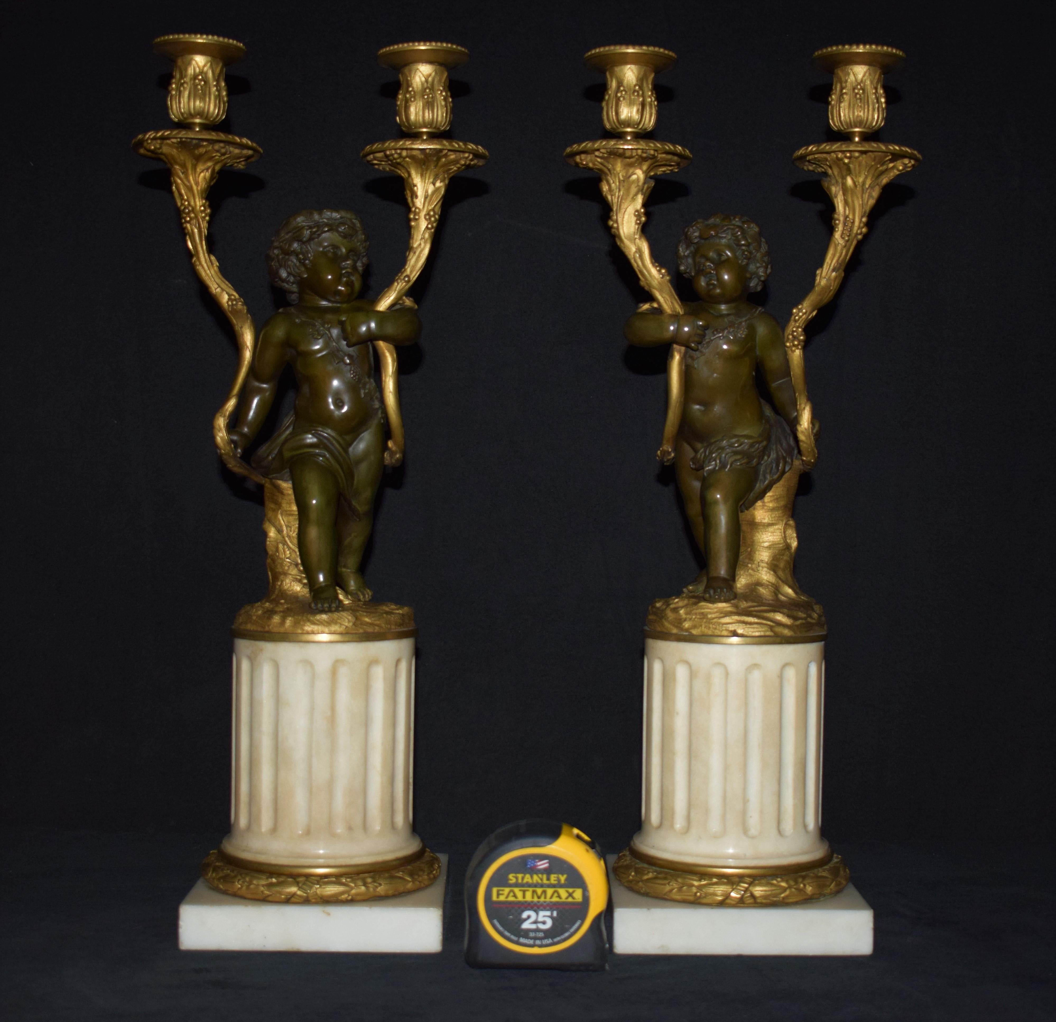 A fine and decorative pair of Louis XVI style parcel-gilt and patinated bronze candelabra. Raised on white marble reeded columns resting on square bases, France, circa 1900
Dimensions: Height 21 inches x 6