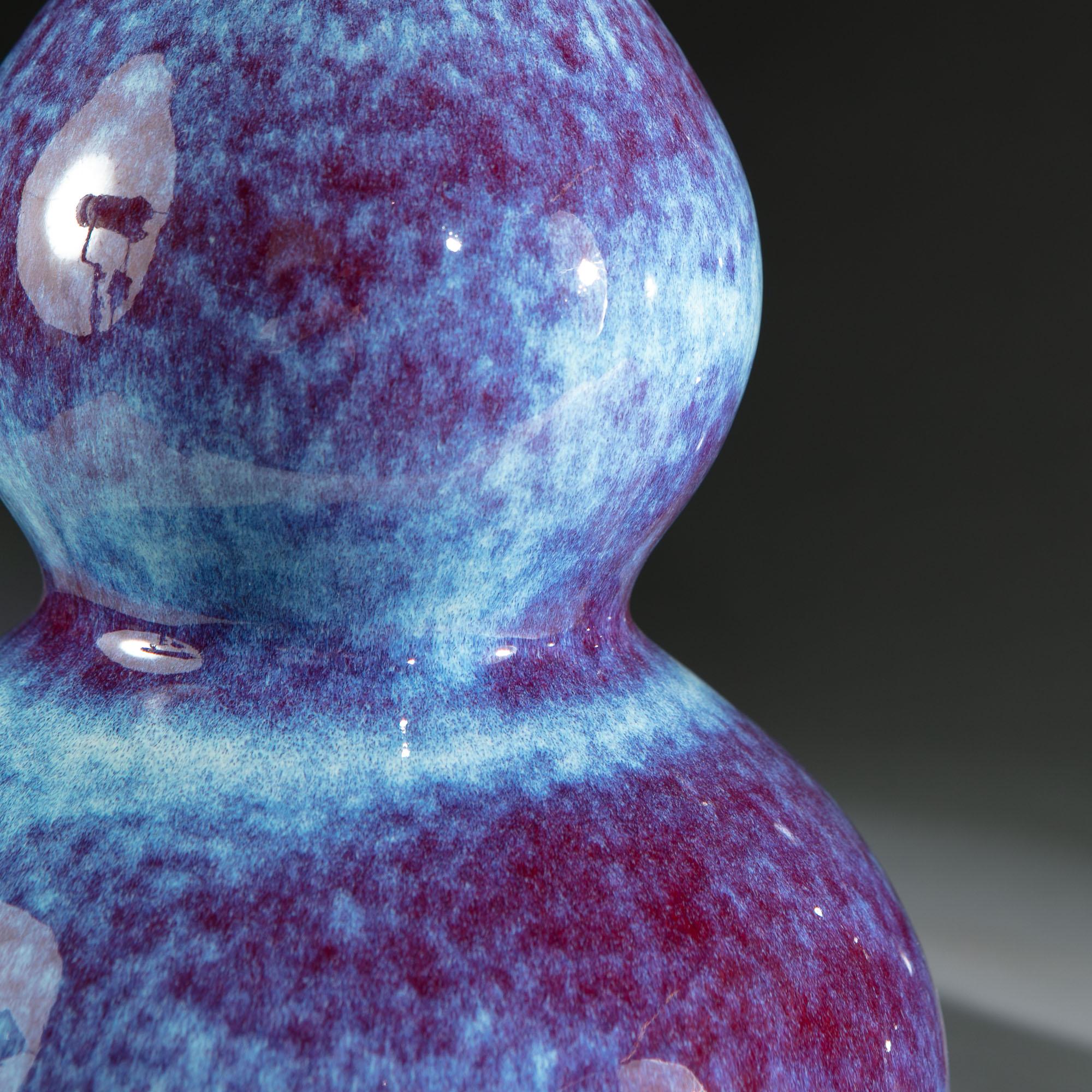 A pair of 20th century Chinese double gourd form vases, with fine red and blue flambé glaze, now converted as lamps.

Please note: Lampshades not included.

Currently wired for the UK.