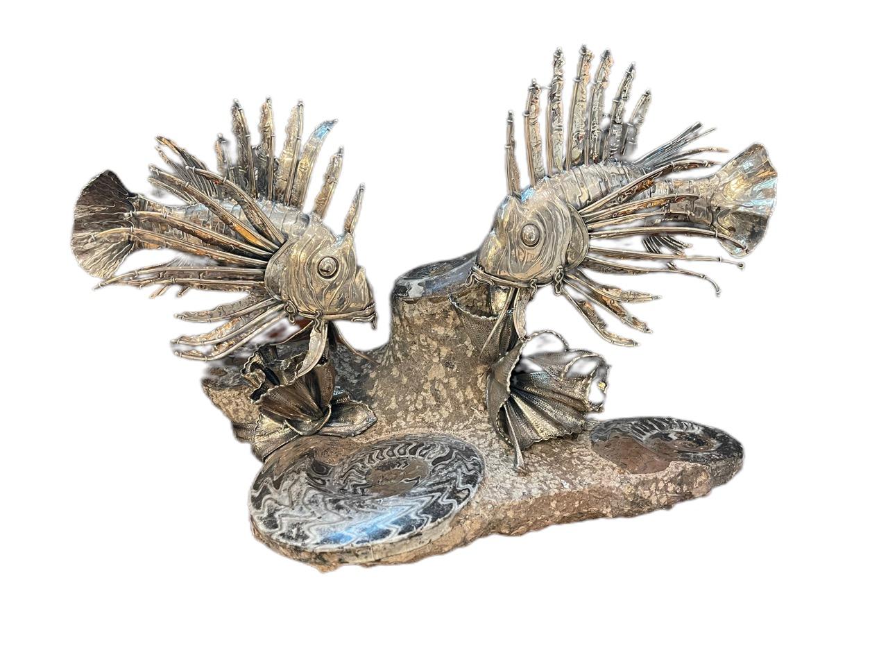 A pair of 20th century, Italian silver Lionfish, by Mario Buccellati from Milan. The realistically modeled fish detachable from the silver seaweed mounted on the fossilized marble base. Buccellatti is recognized as one of the most prestigious