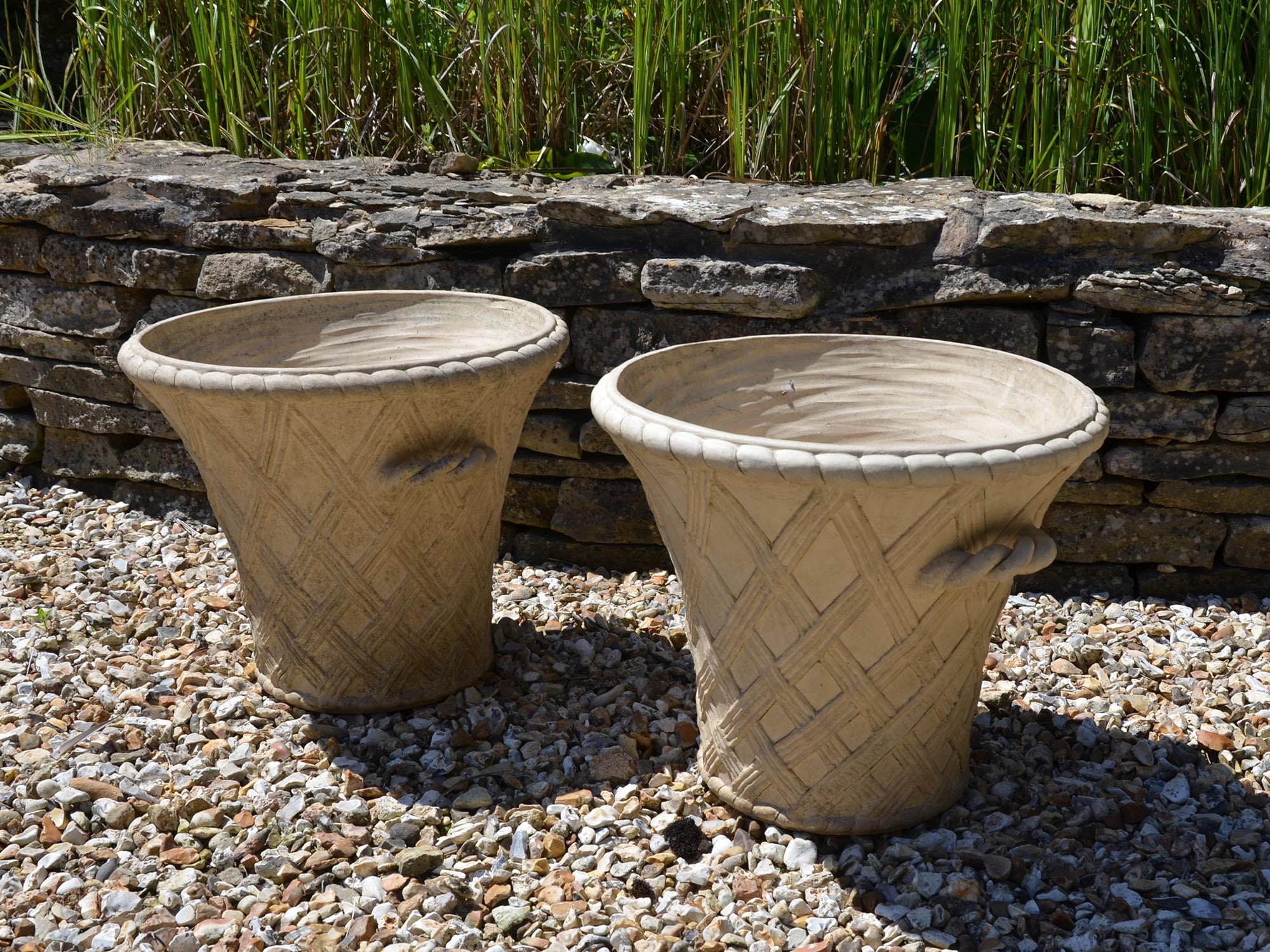 A pair of 20th century terracotta garden planters by Philip Thomason, of fluted tub shape with lattice design to the body having rope twist handles and a rope twist motif to the top lip.