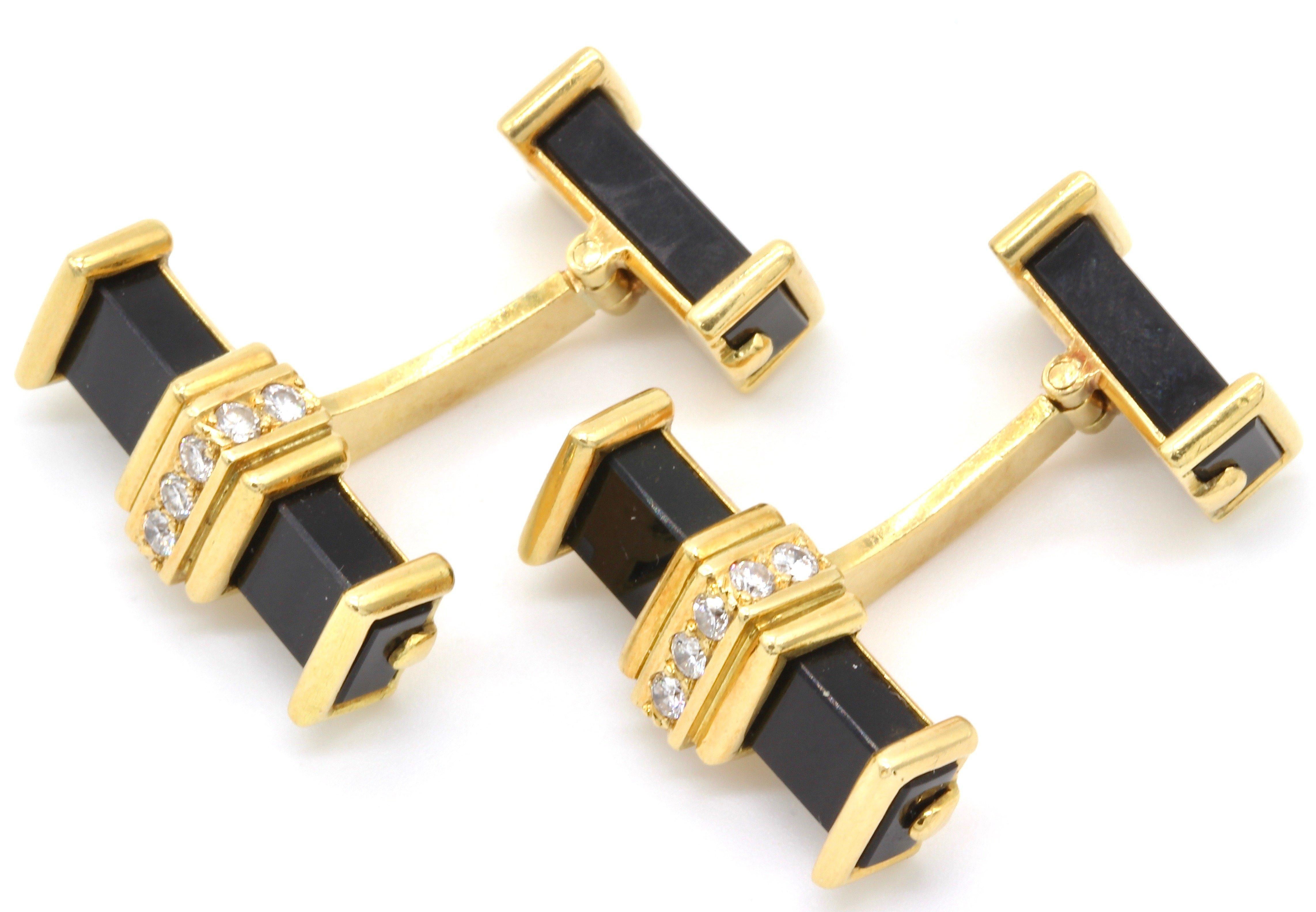A pair of 9 Kt gold diamond and black onyx bar cufflinks. The black onyx bar with a central yellow gold collar set with seven round cut diamonds, the smaller hinged bar with yellow gold terminals. 
Total diamond weight 0.28 Ct